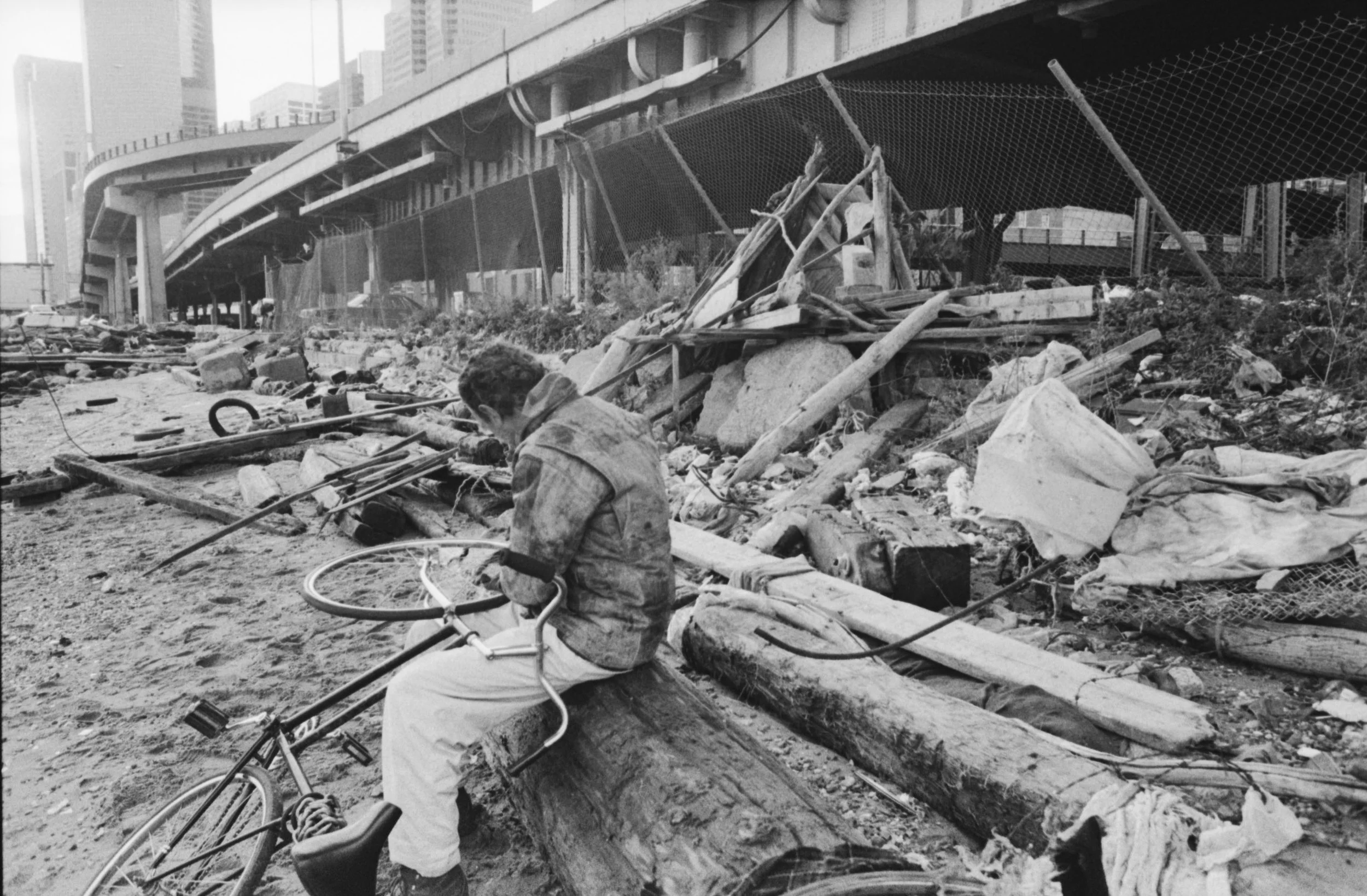  Chris Piper working on his bike under the Brooklyn Bridge, 1995 