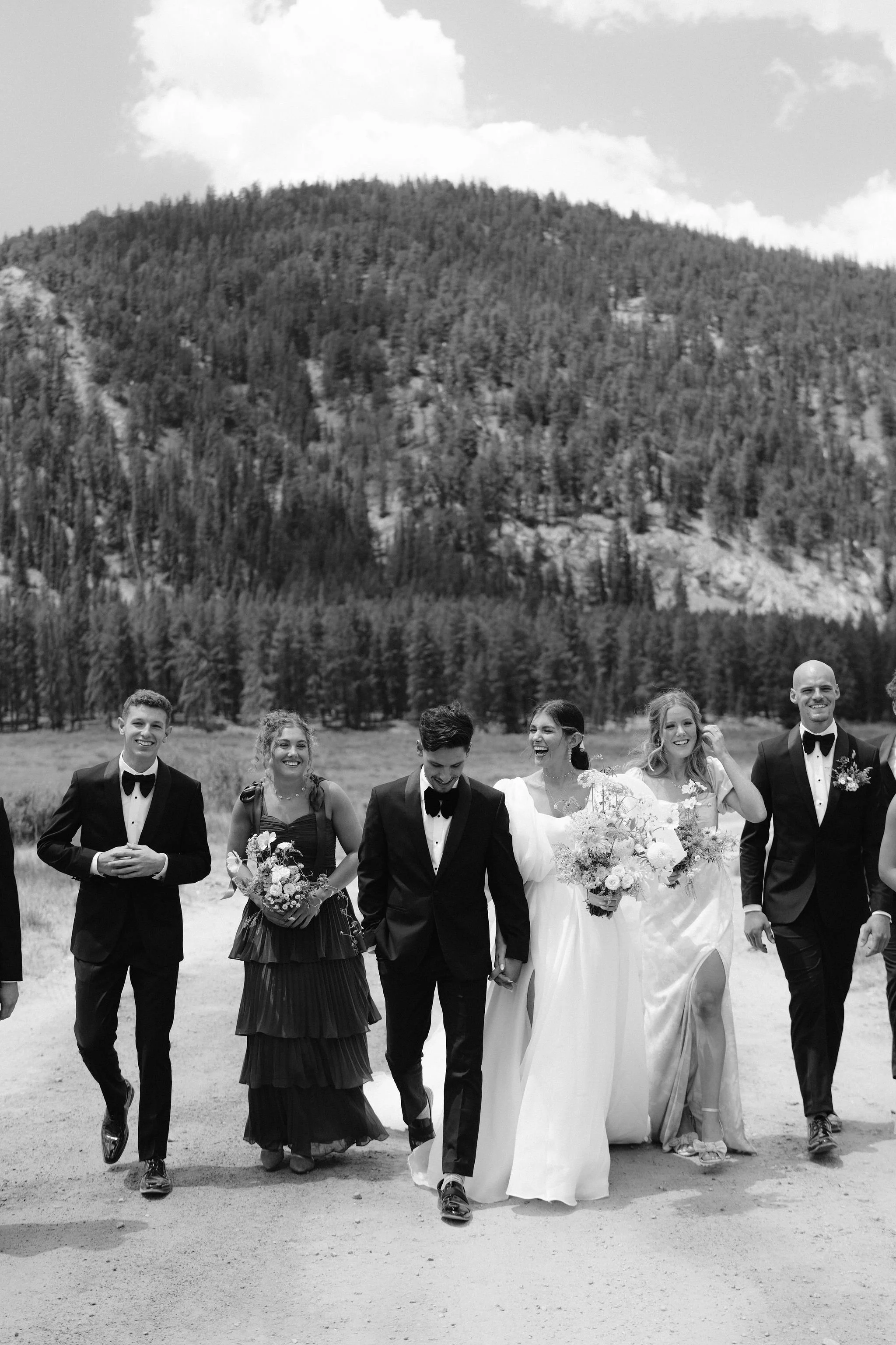 bride and groom walk with their bridal party to the church in tin cup