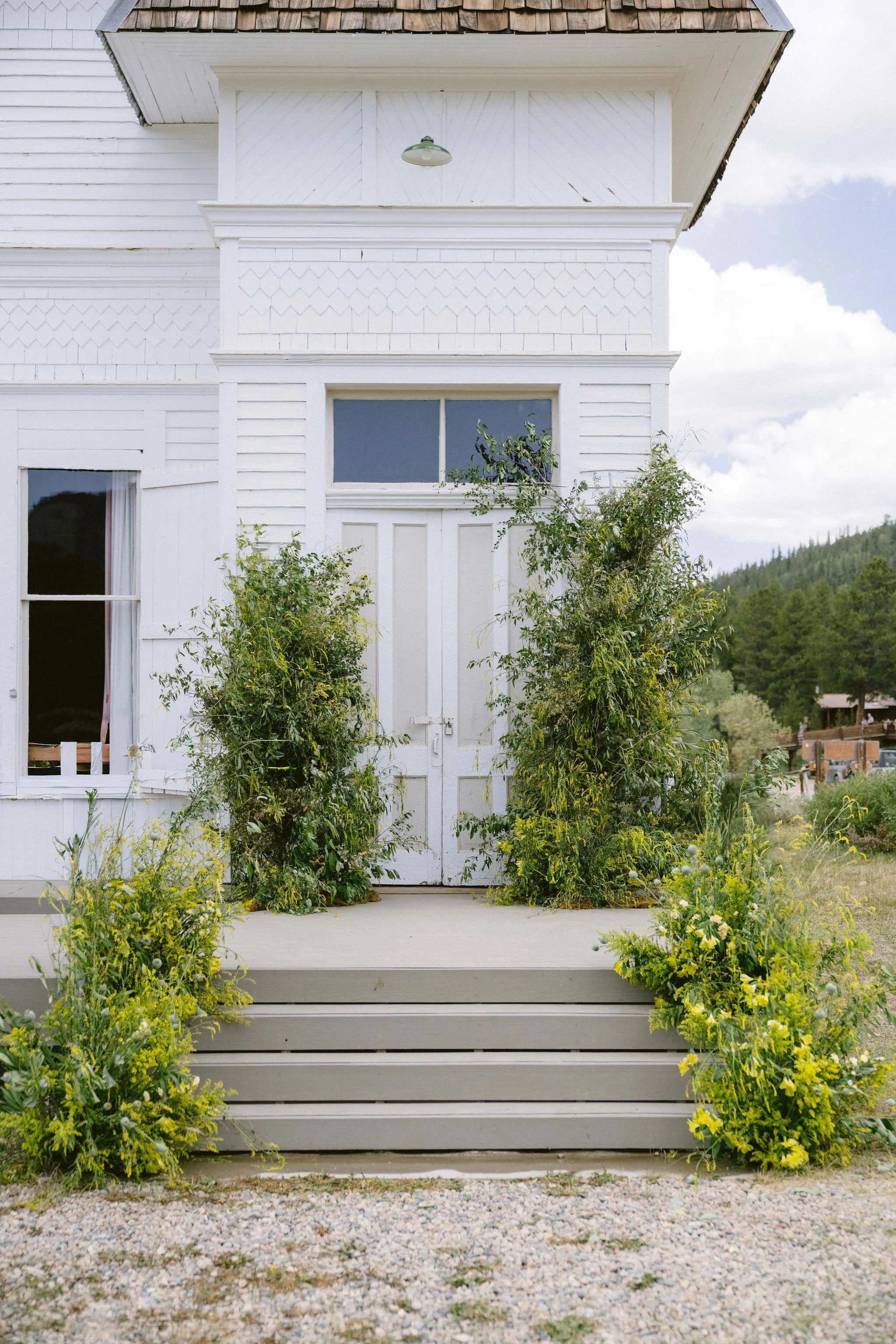 yellow wildflower floral arches welcome guests to the tin cup chapel