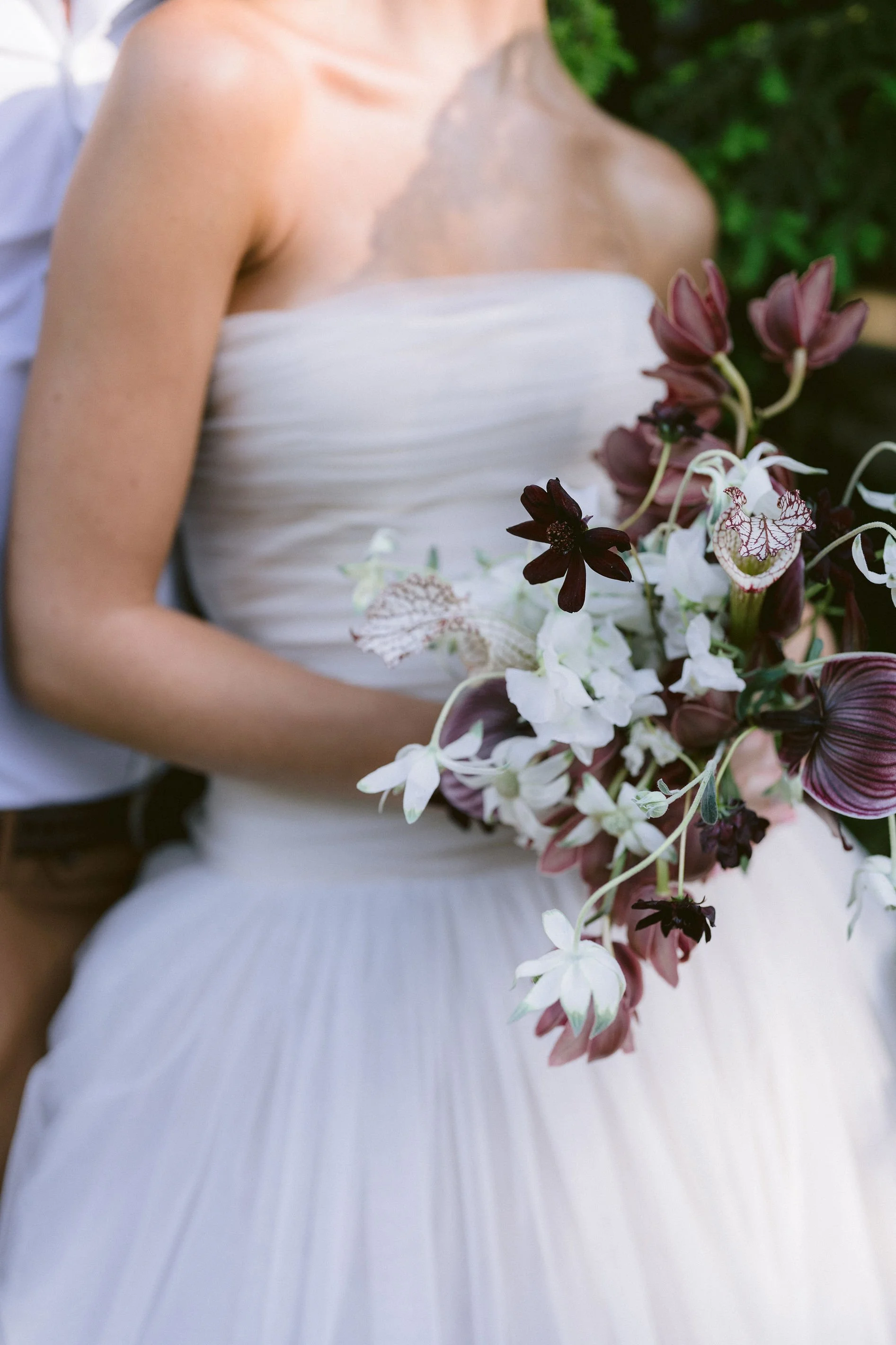 white and burgundy bridal bouquet with orchids and calalillies