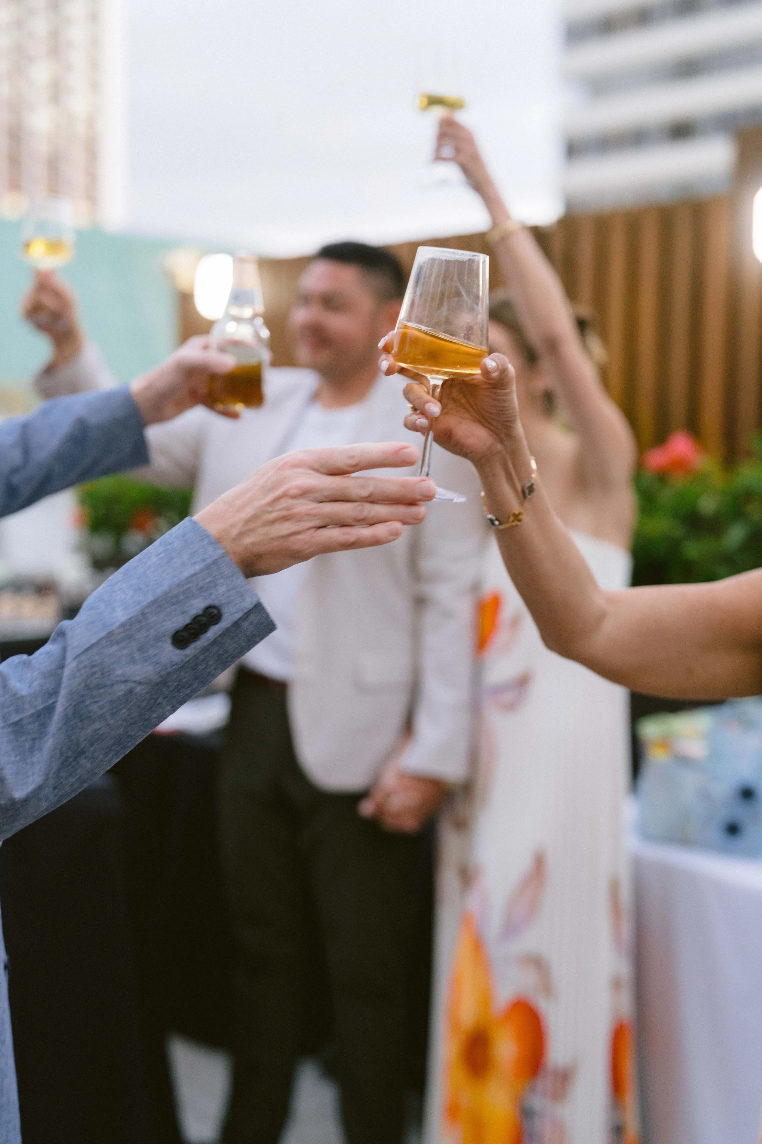wine glass cheers at alohilani resort wedding welcome party