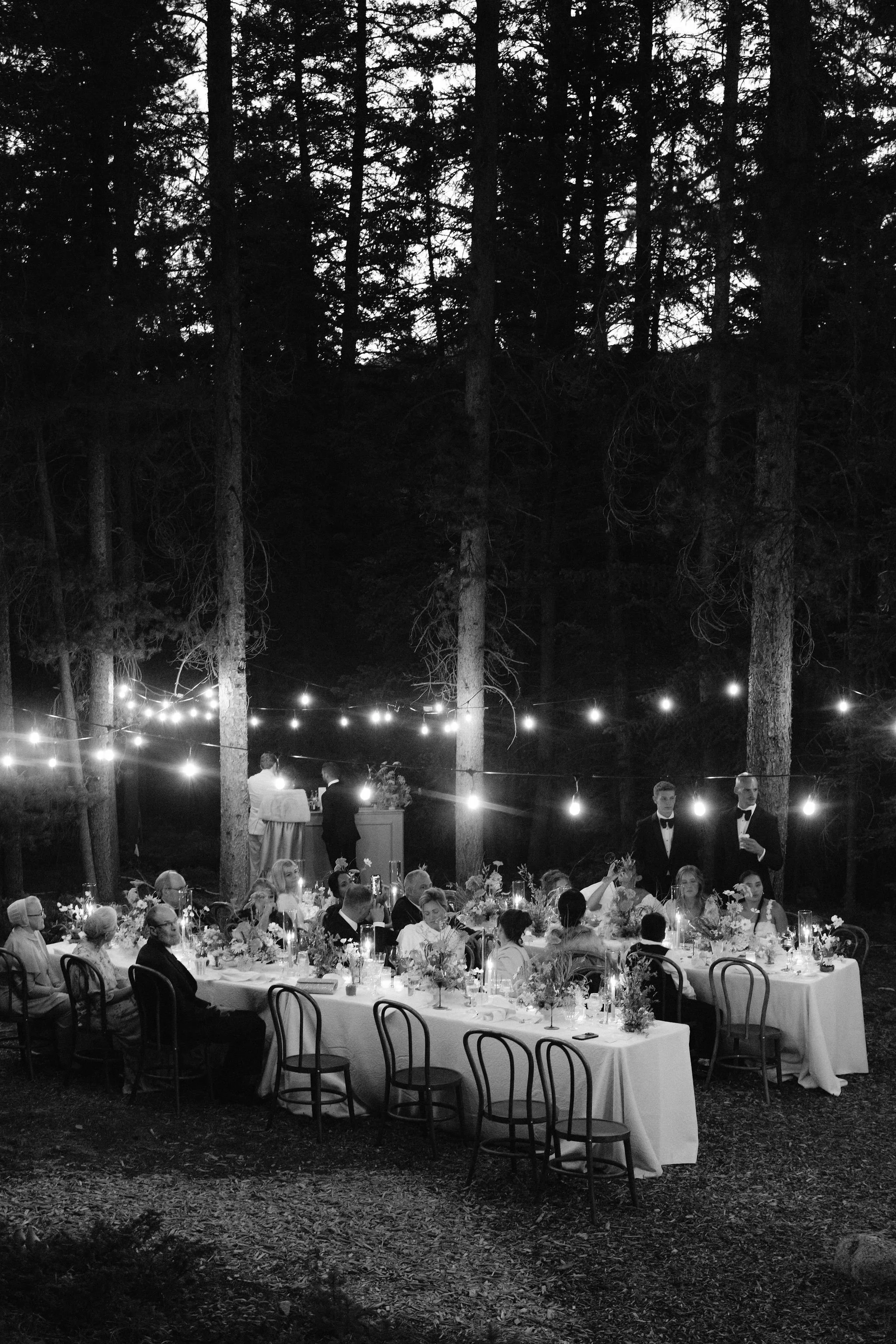 black and white photo of the reception at nightime with string lights