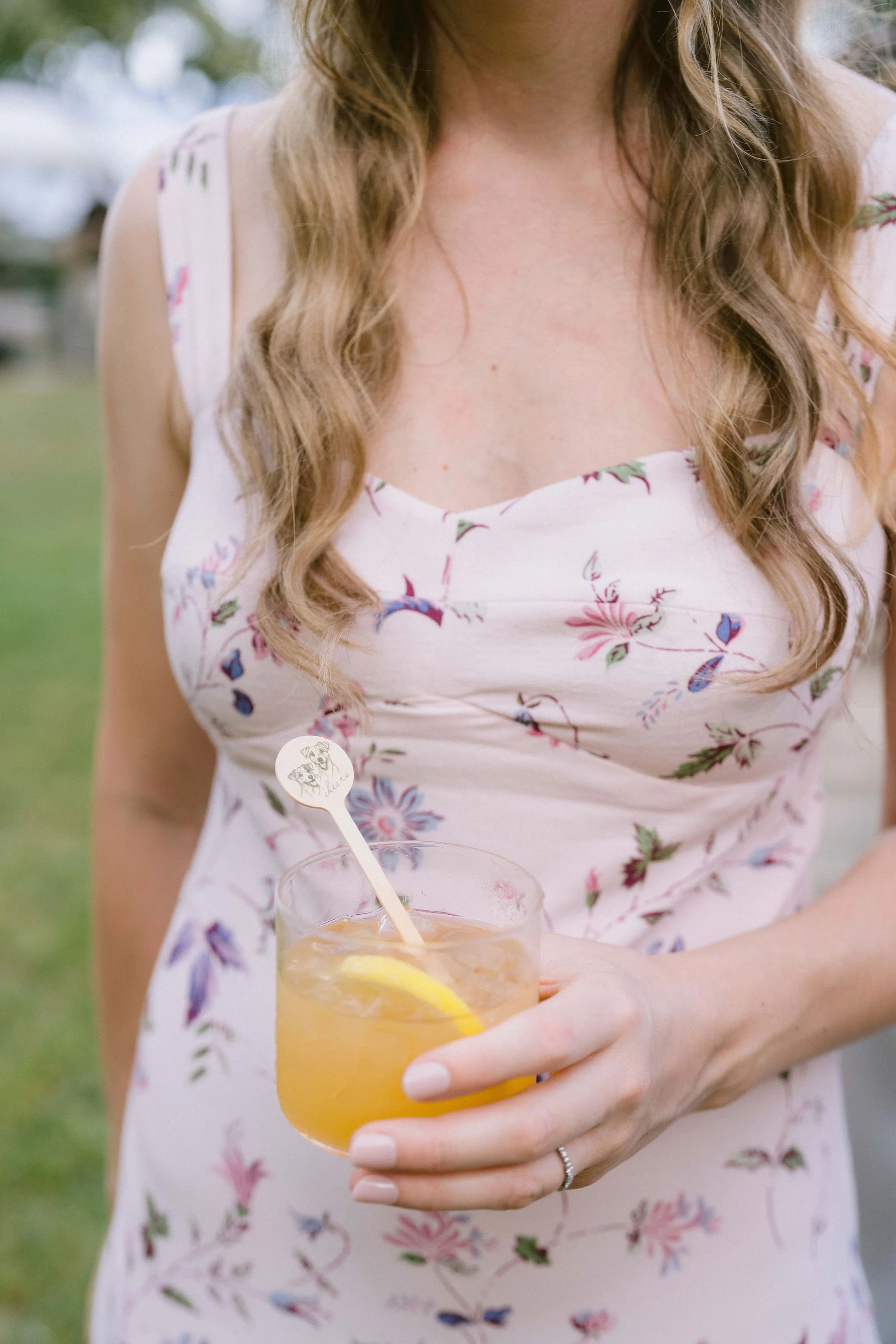 cocktail hour signature drink with custom stir stick with couple's dogs