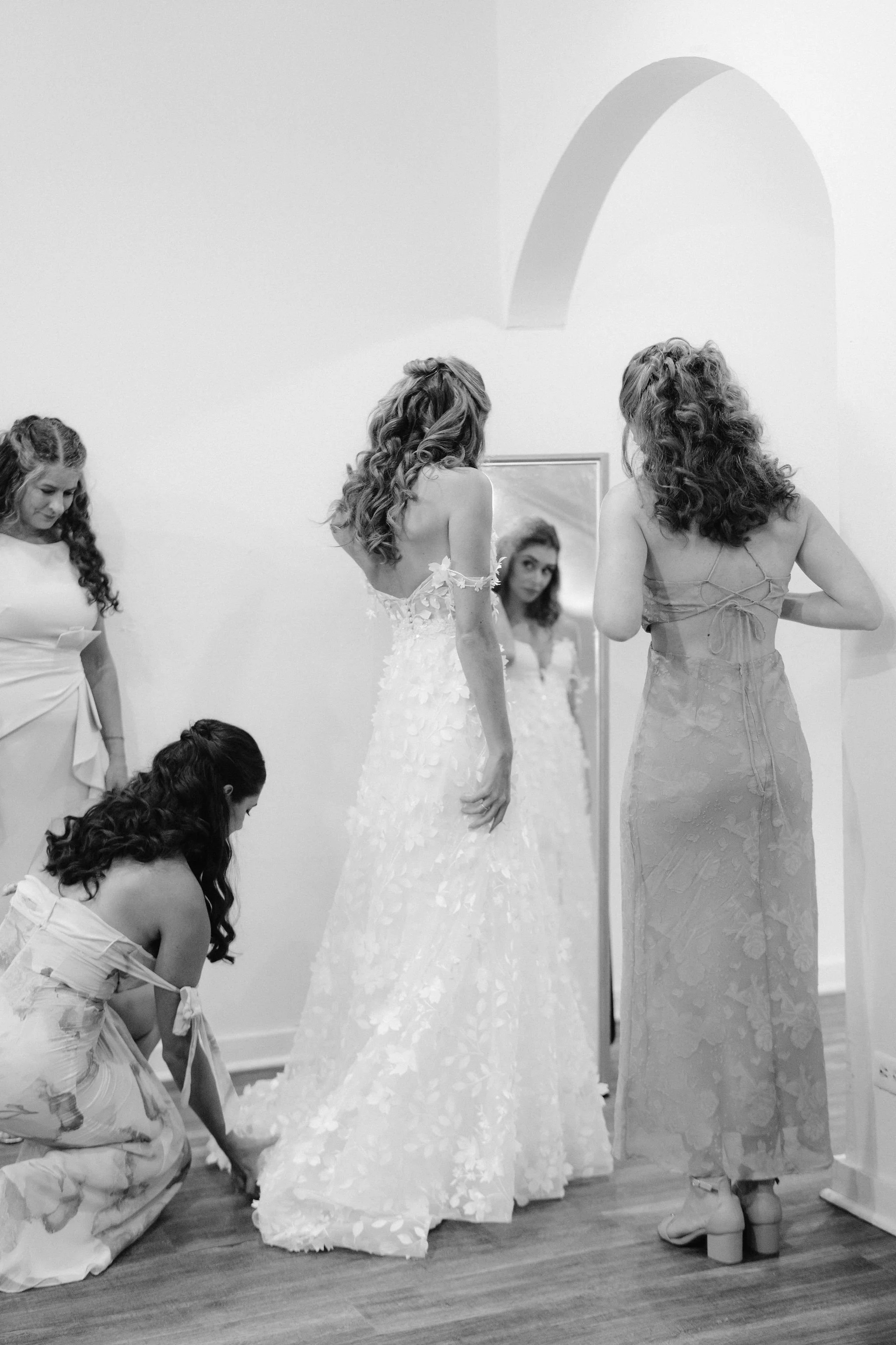 brides gets into her wedding dress at kualoa ranch for her wedding