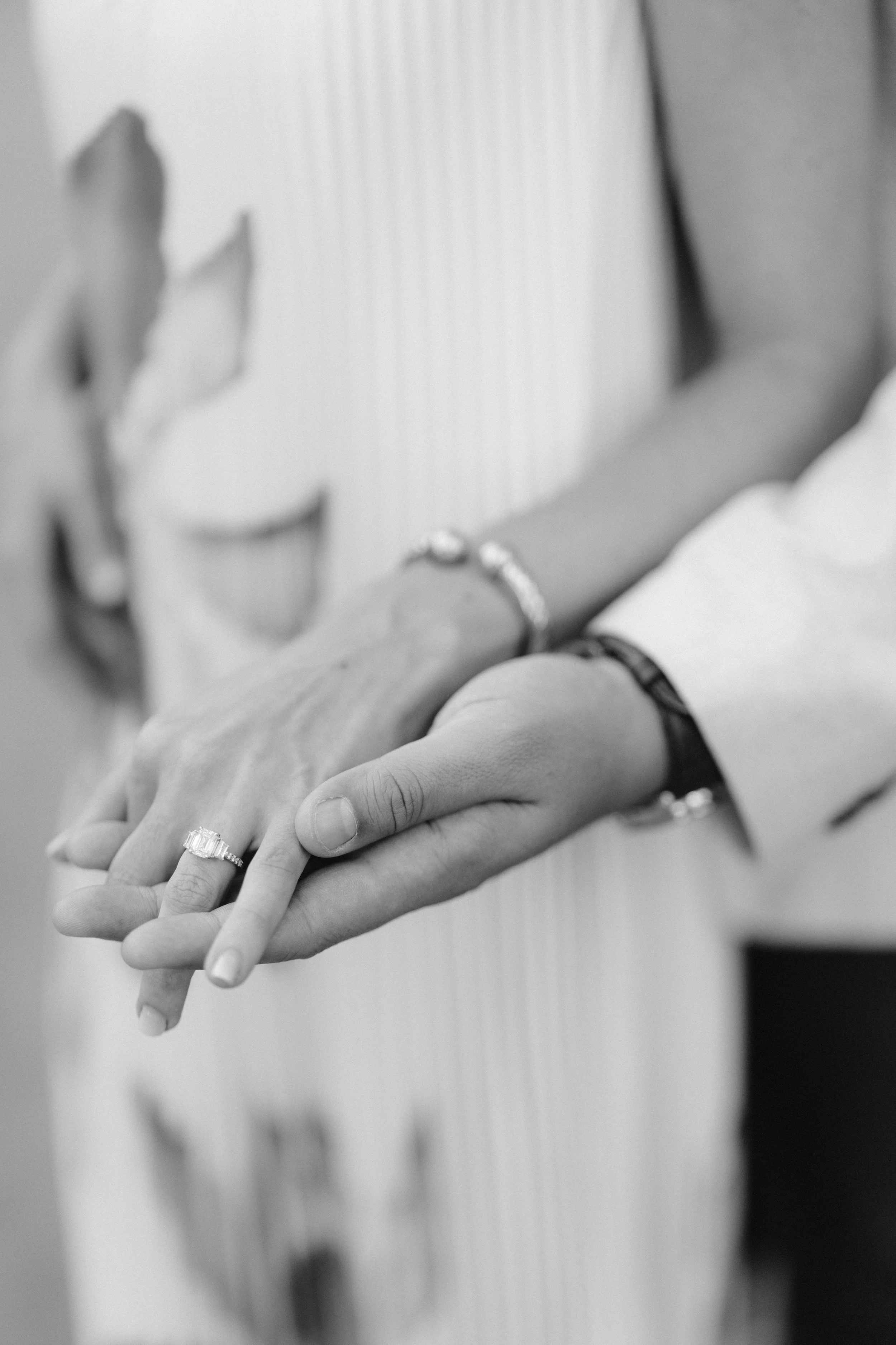 bride's engagement ring with her hand in hand with her fiance