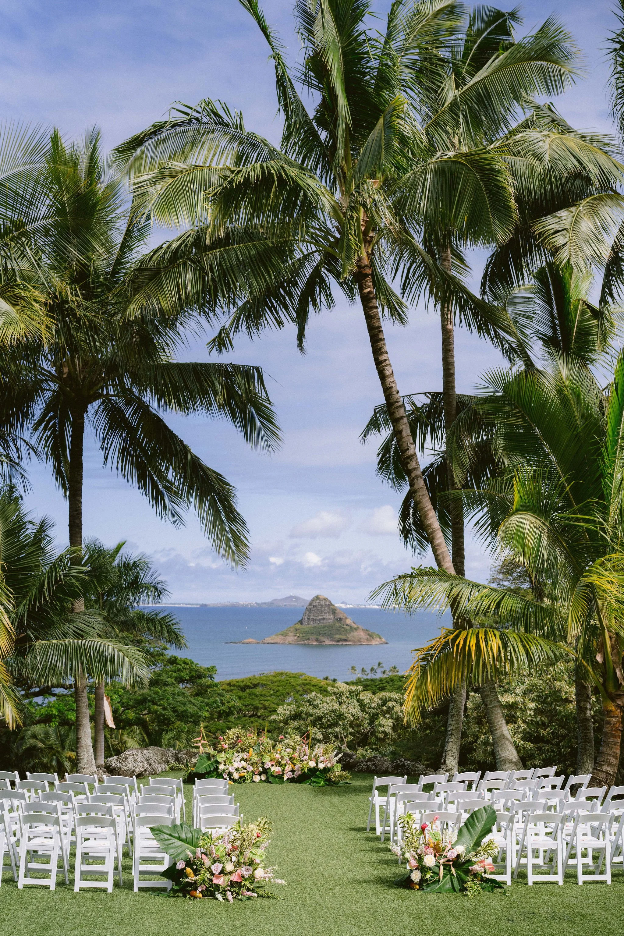 ceremony set up at kualo ranch wedding with tropical blooms and sunshine