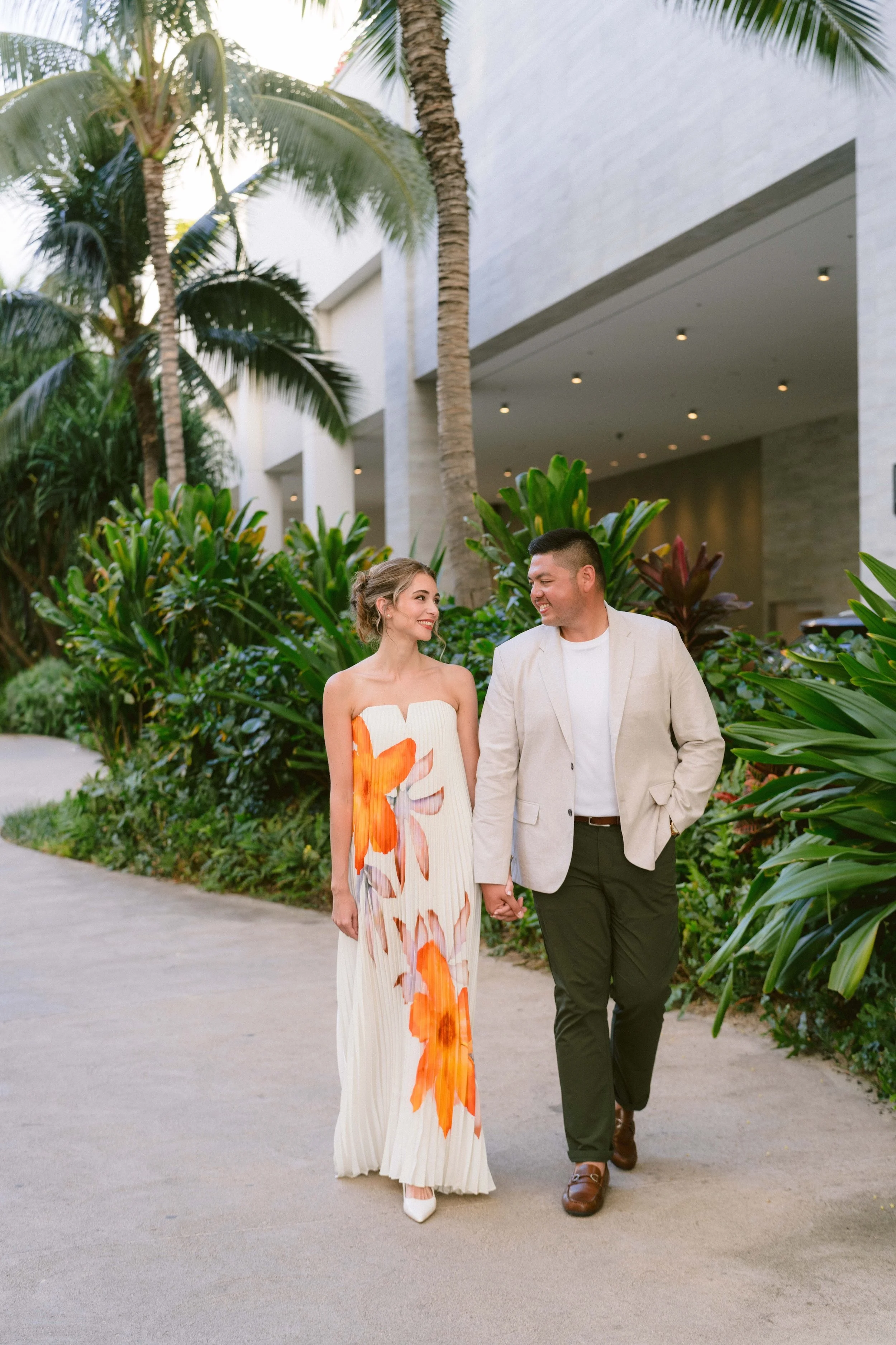 couple walks to alohilani resort from wakiki beach for their wedding welcome party