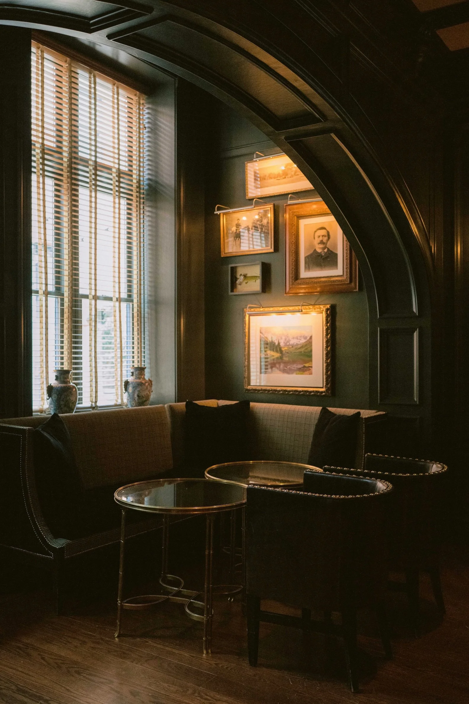 Corner seating in the bar at Hotel Jerome with moody lighting