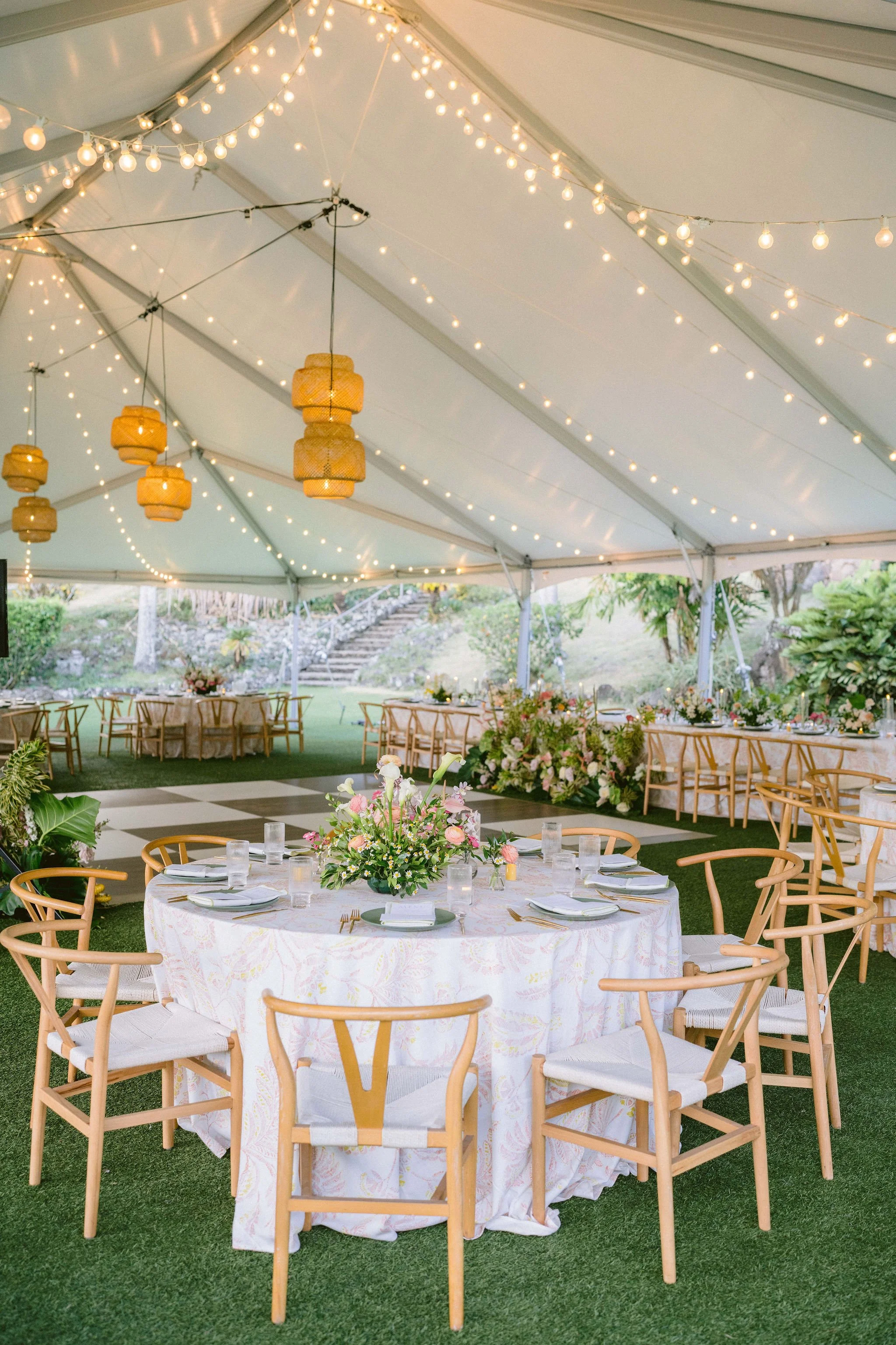 wedding reception that is bright and floral under the tent at kualo ranch