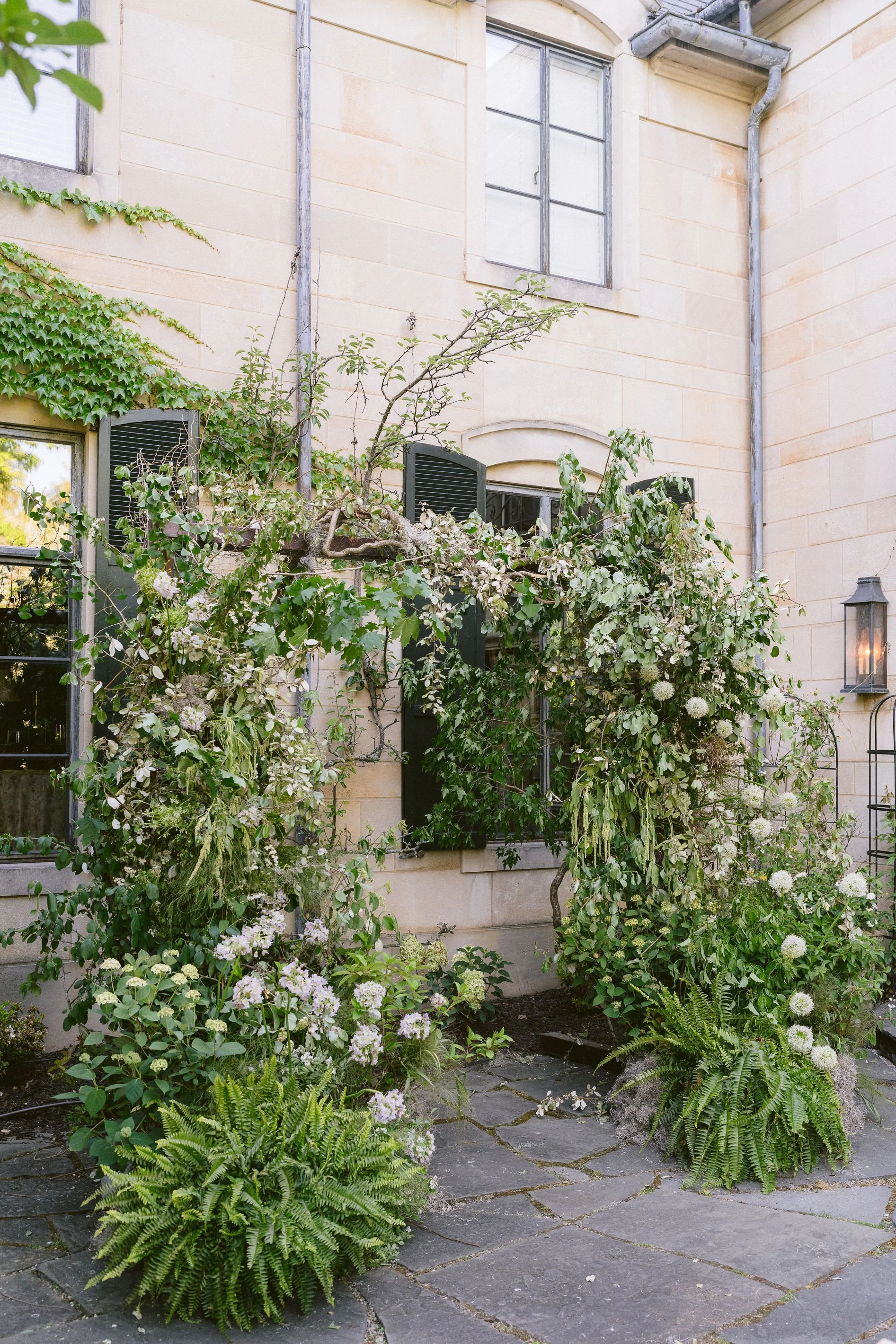 stunning and lush all green floral arch for ceremony on the terrace at greencrest manor