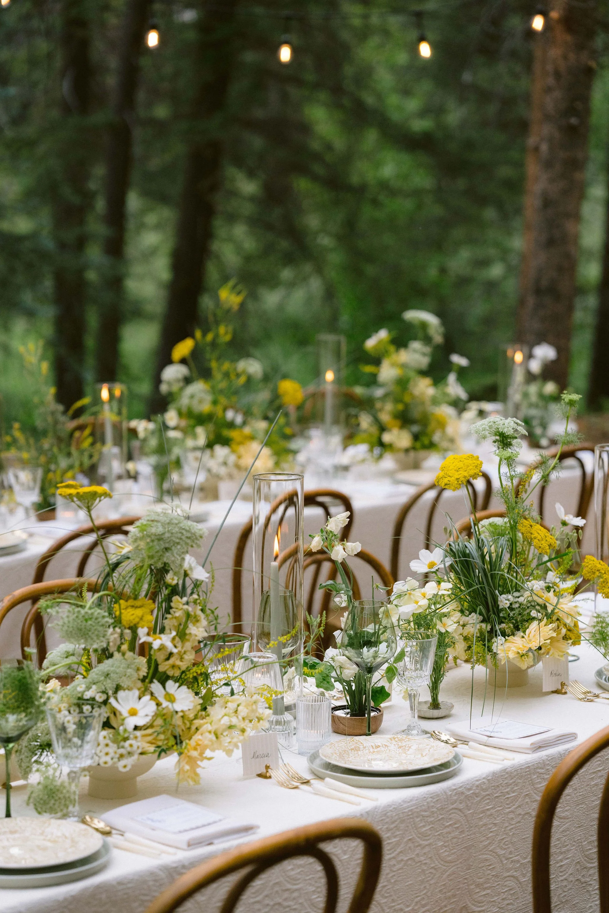 details of the tablescapes with yellow florals and lots of beautiful patterns for wedding reception