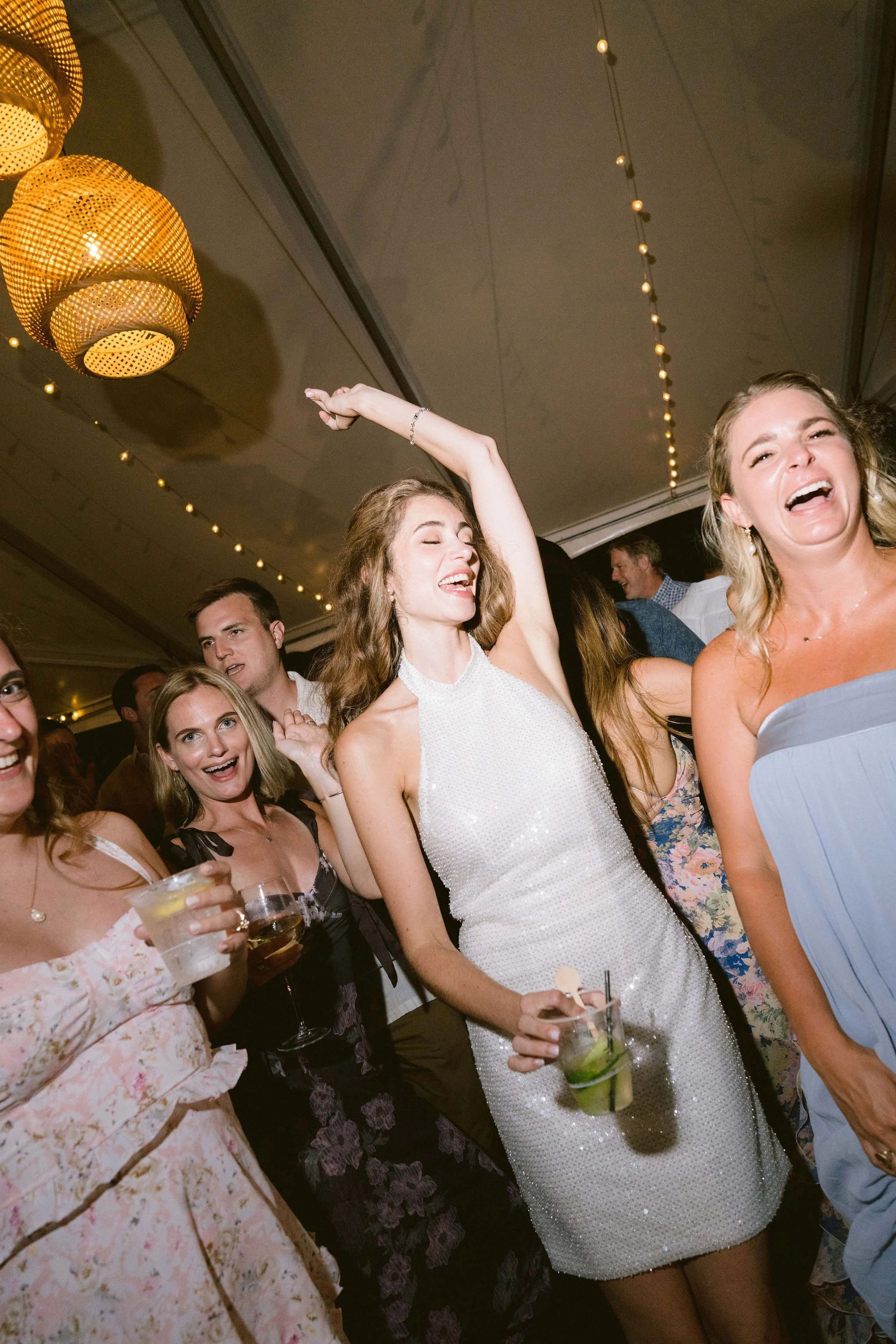 bride and friends dancing to live band at kualoa ranch wedding reception