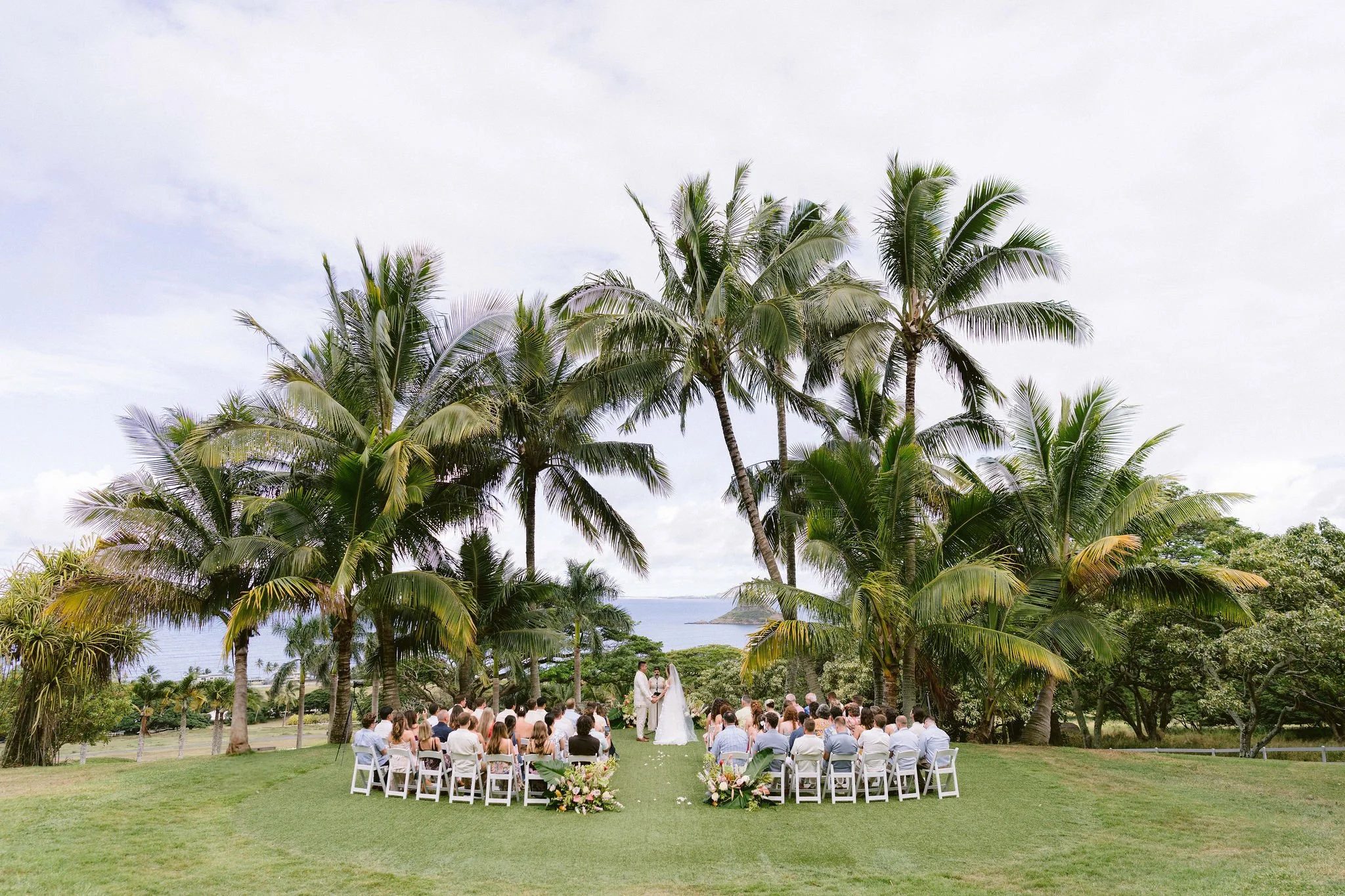 bride and groom exchange vows with dramatic landscape backdrop at kualo ranch