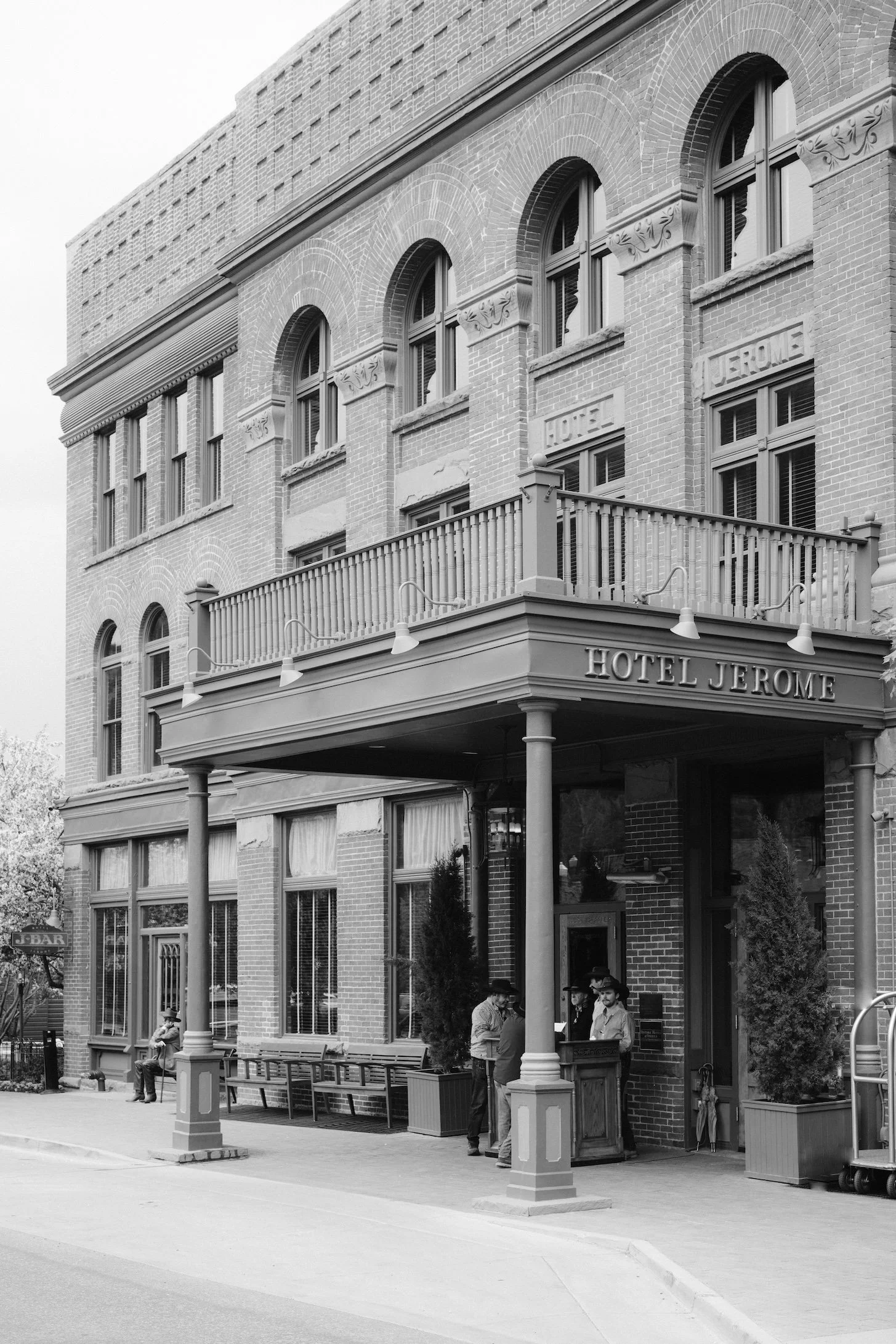 The front of Hotel Jerome in Aspen with a couple of valet guys in cowboy hats standing outside