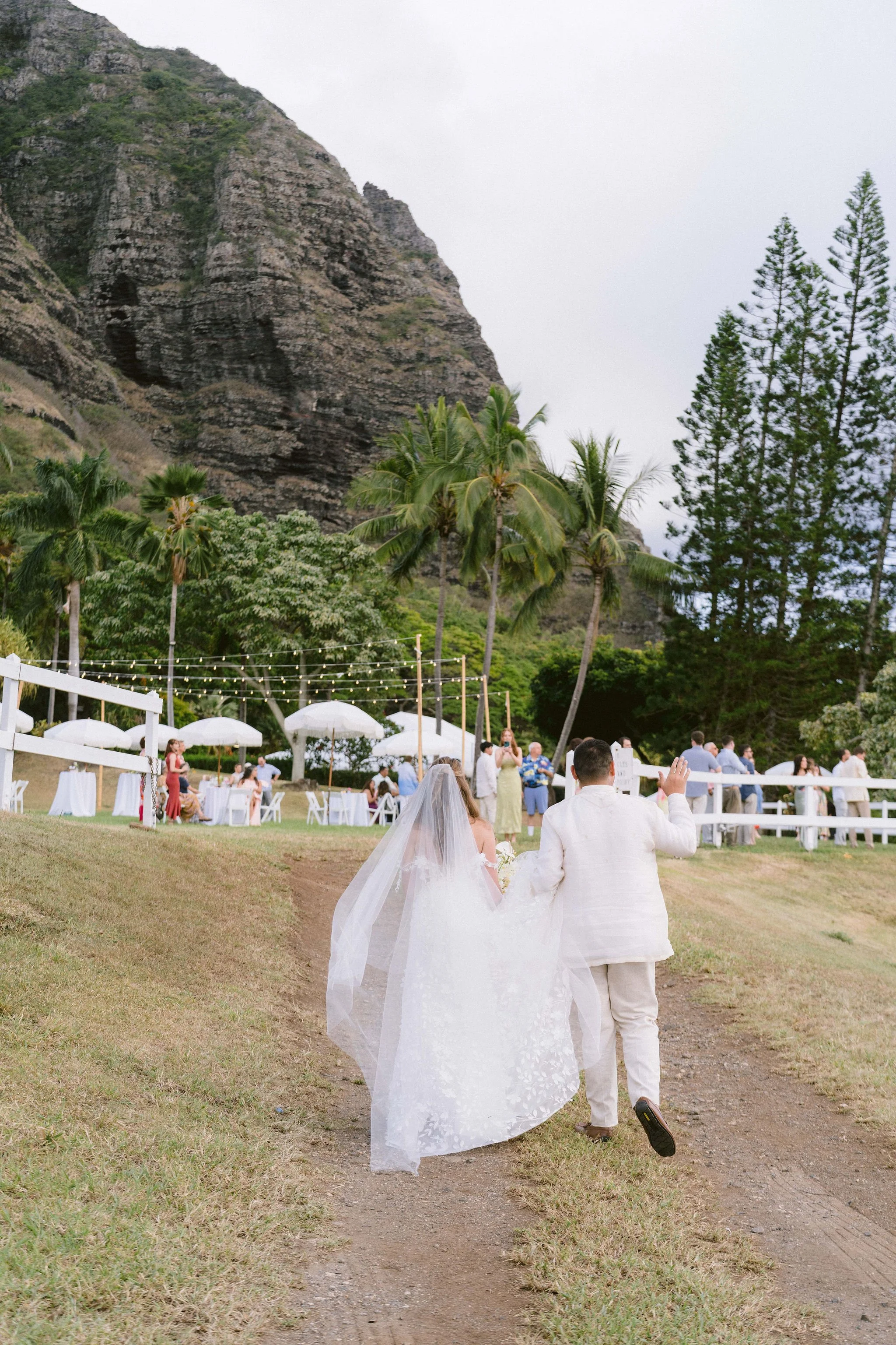 bride and groom greet guests as they walk into cocktail hour at kualoa ranch