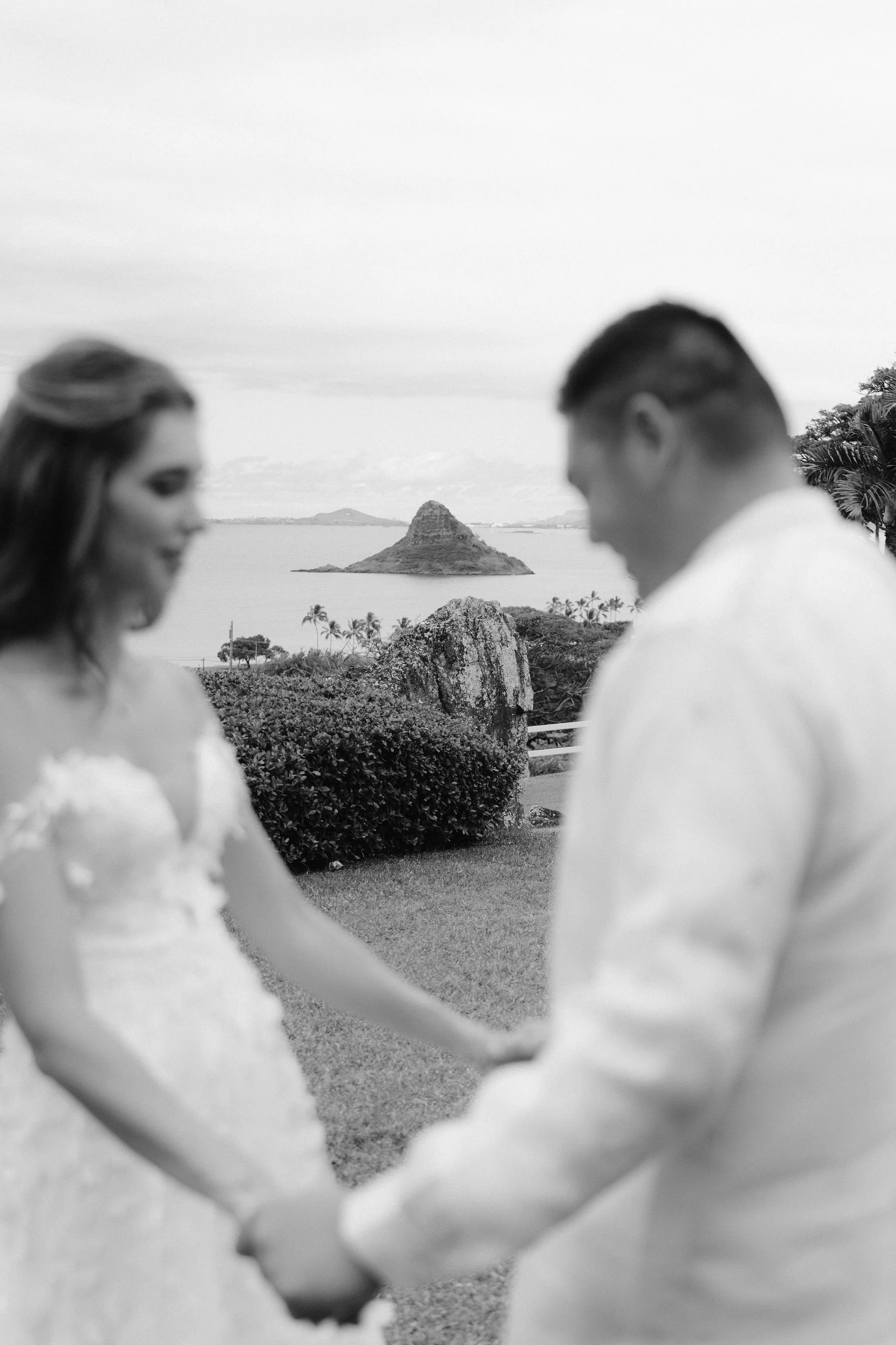 bride and groom in the foreground with the china man hat in focus in the background