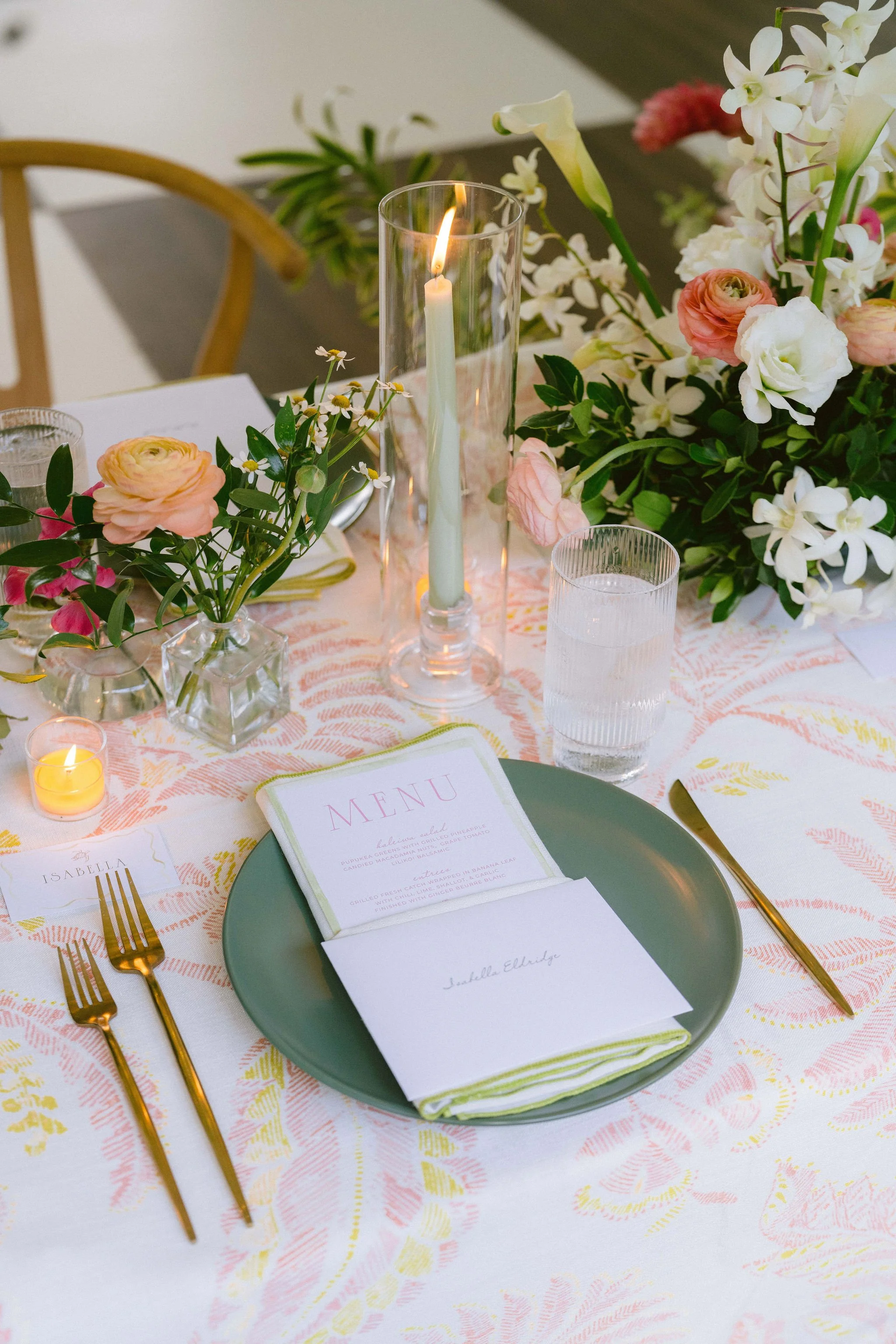 menu and place setting with floral tablecloth at kualoa ranch wedding