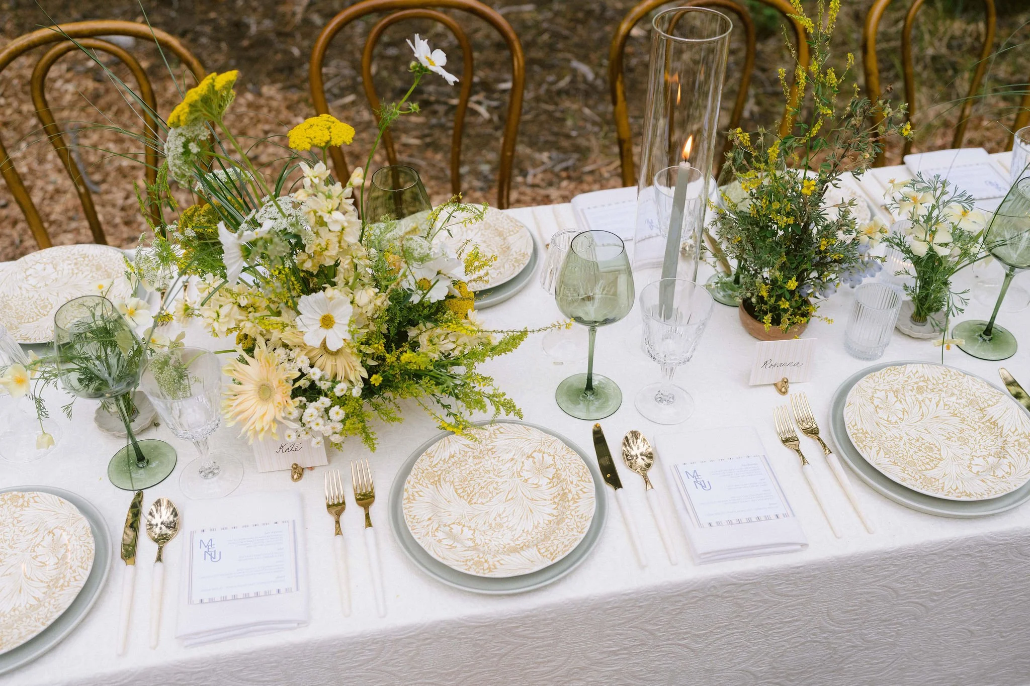 yellow floral plates and white silverware with yellow flowers for wedding reception tablescape