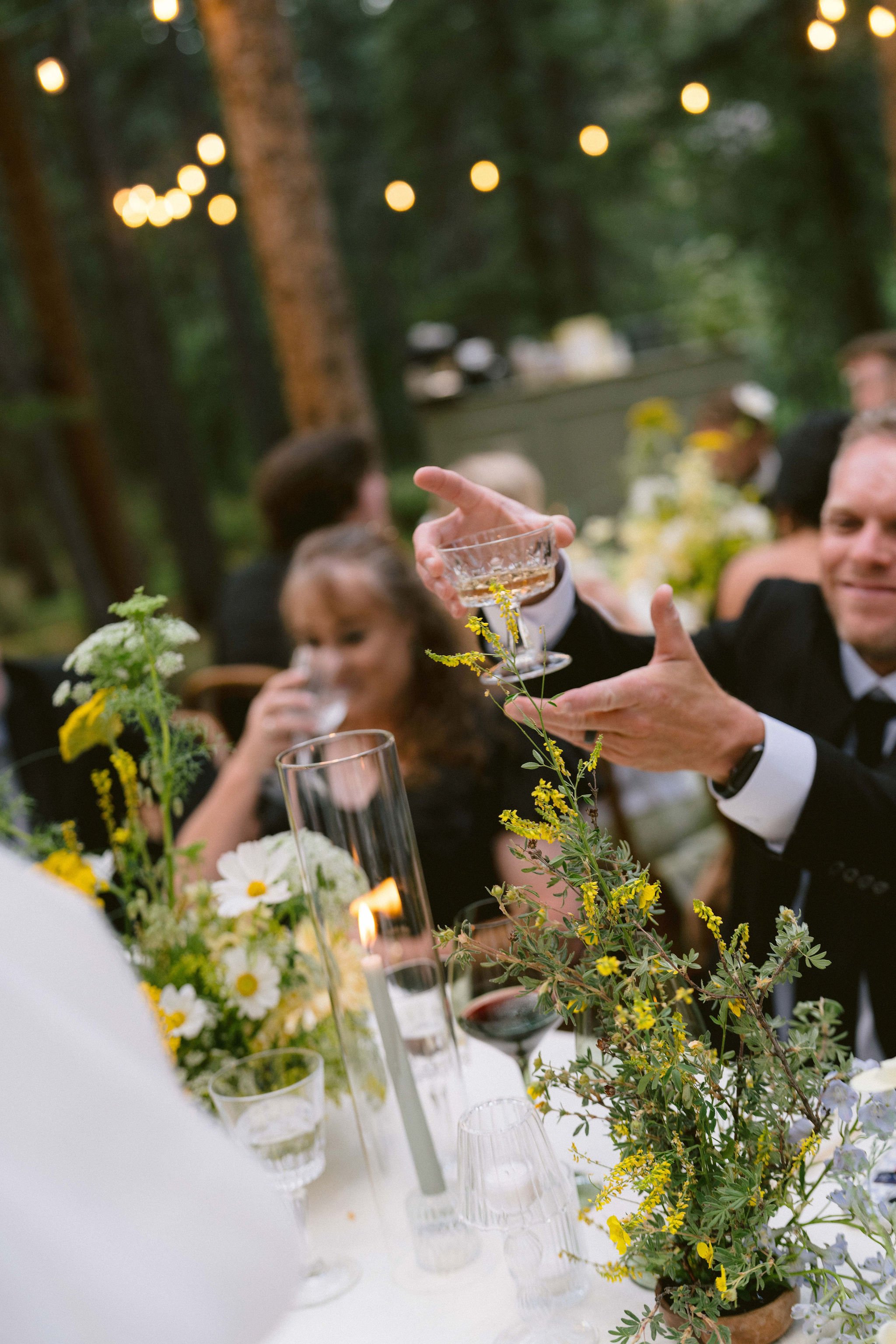 the bride and groom serve their guests champagne