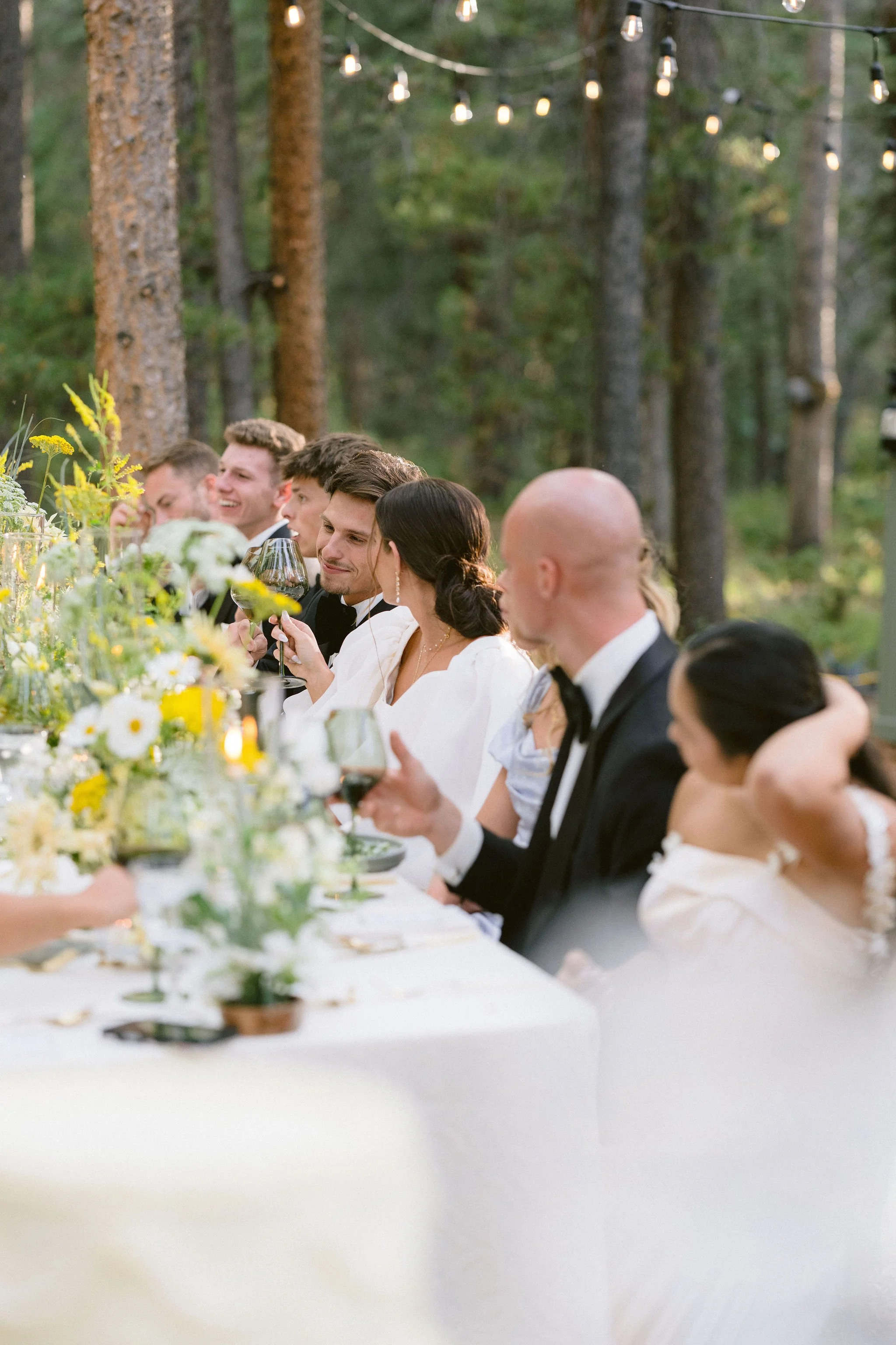 bride and groom exchange a private toast at the table during dinner