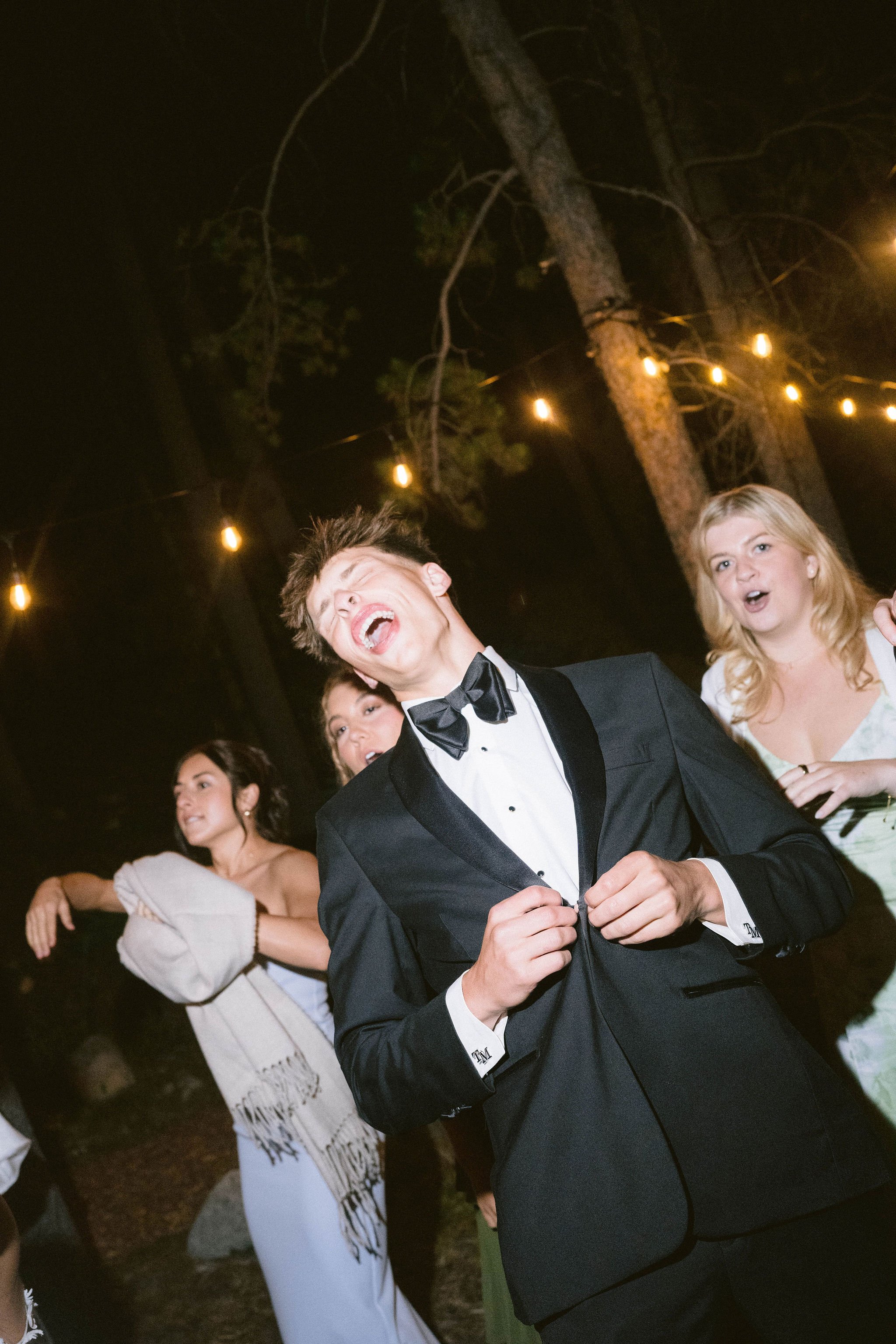 dancing and celebration with groomsmen crying out the lyrics at wedding reception