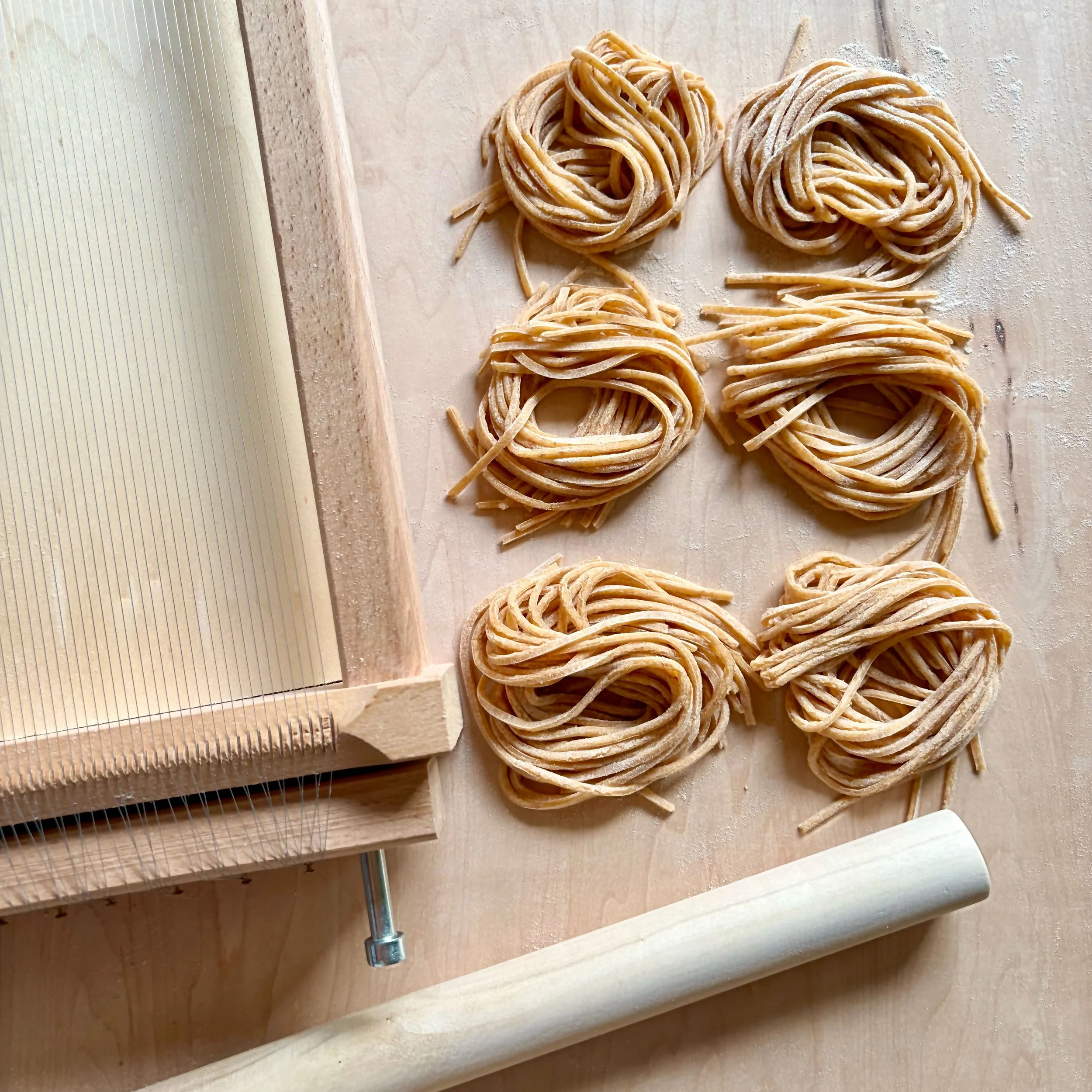 Handmade pasta shaped into nests with chitarra tool