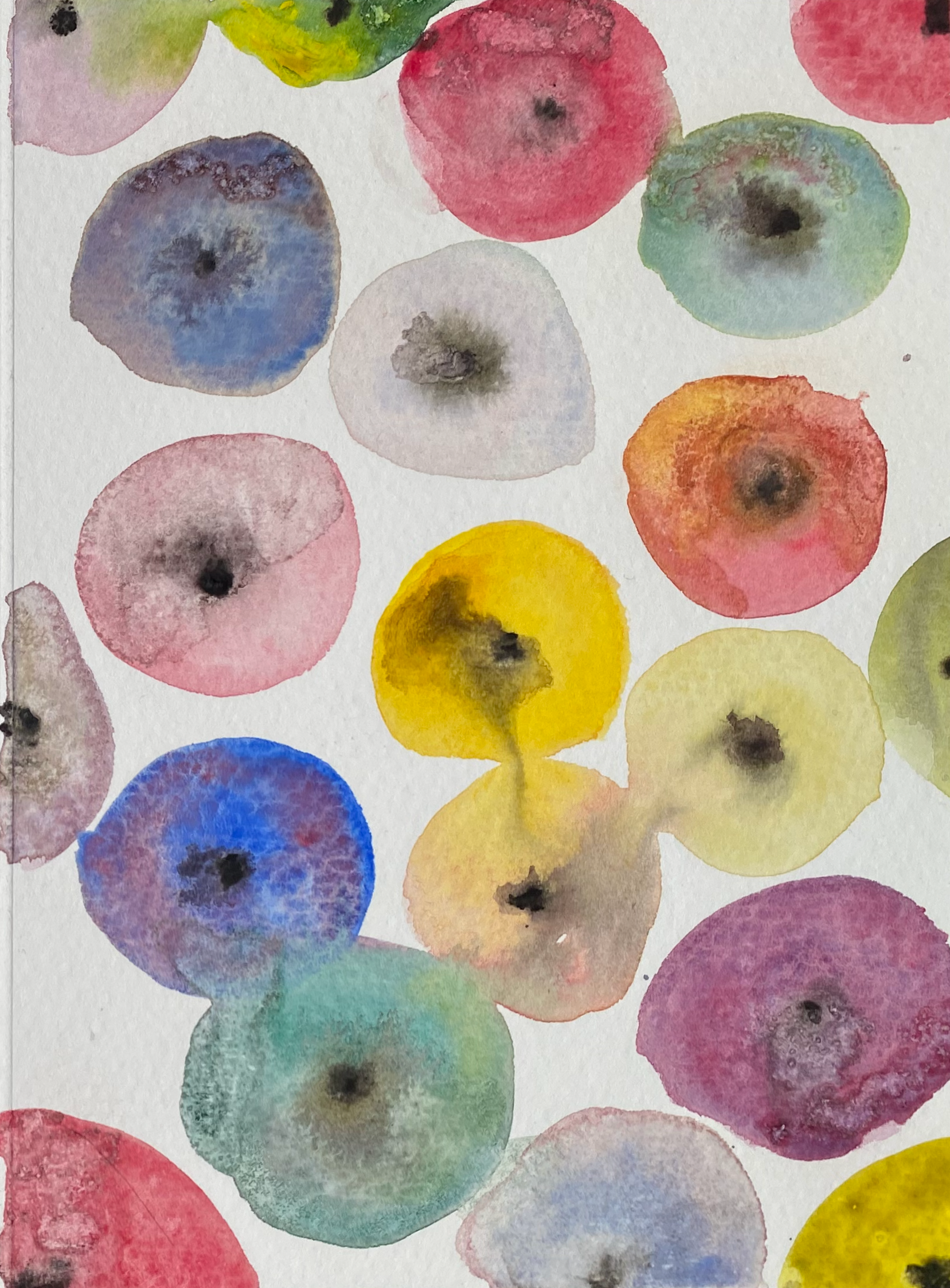 Watercolor painting of multicolored circles in shades of pink, blue, green, yellow, and purple on a white background.