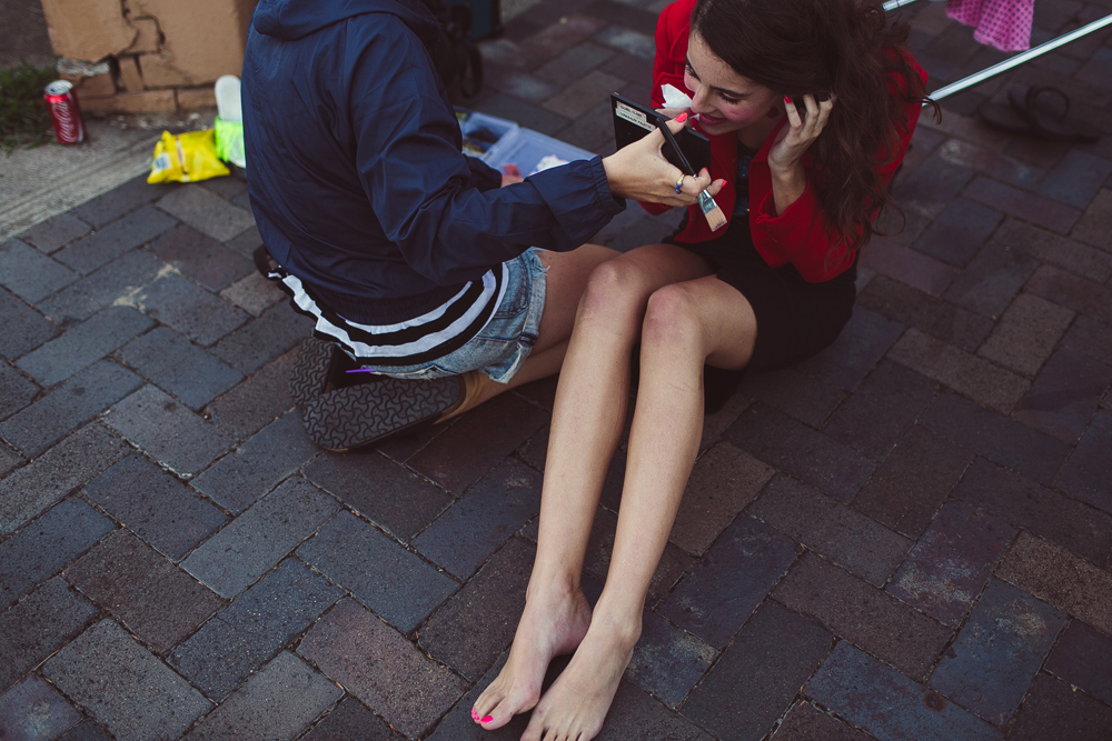  getting makeup done on the sidewalk in the suburbs of sydney. 