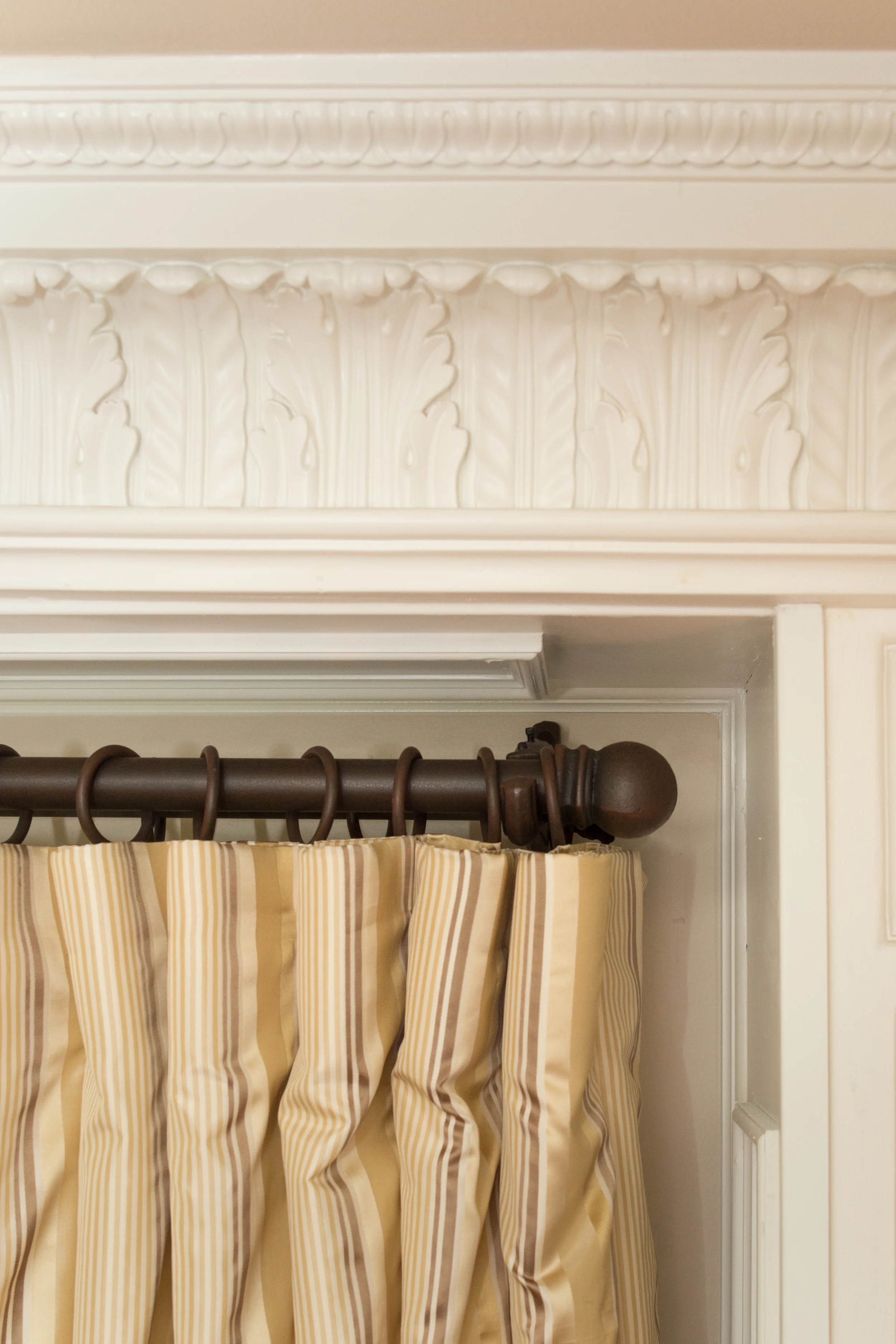 Gorgeous crown moulding is perfectly complemented by custom silk drapes and understated wrought iron hardware.