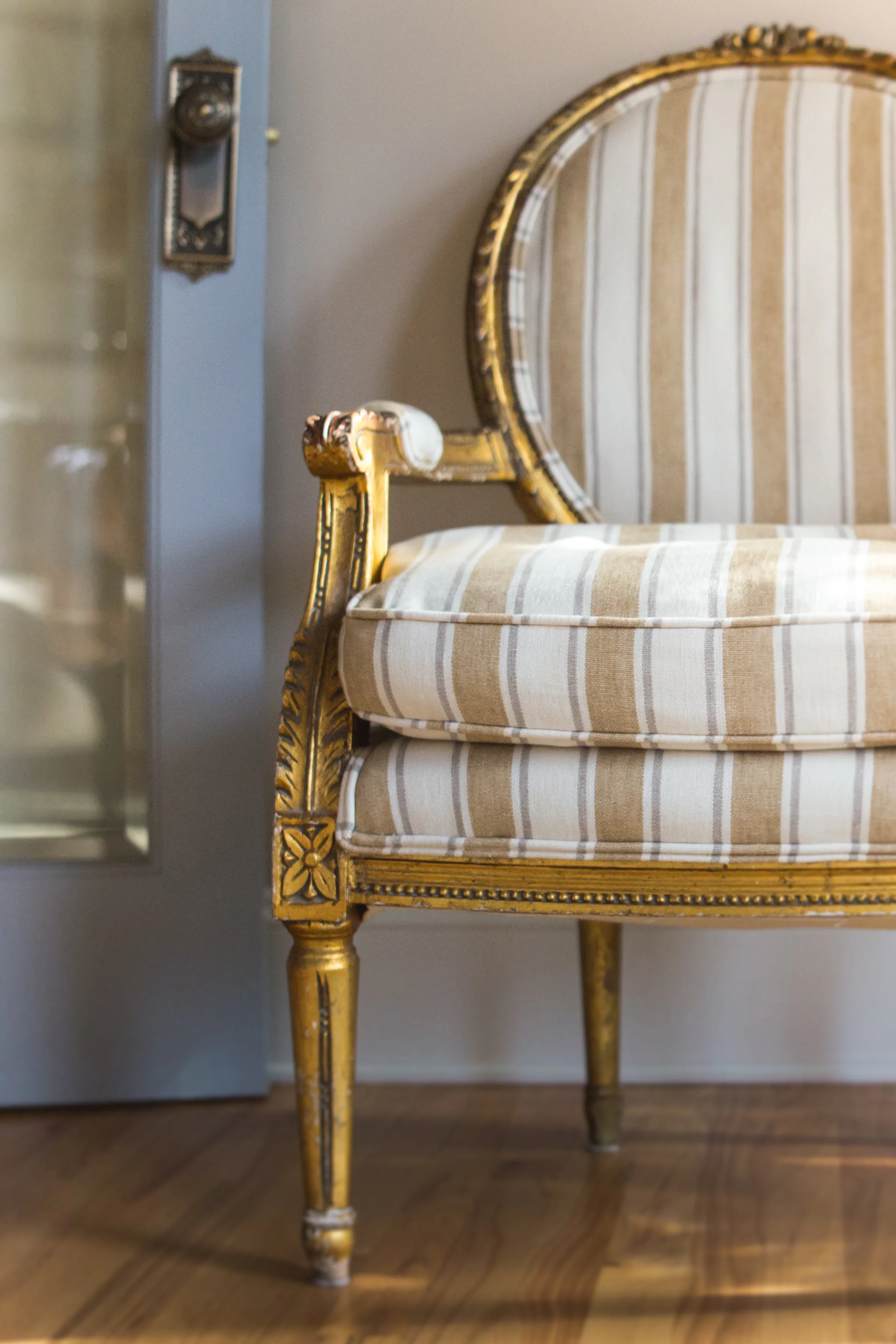 The homeowners antique gilt chair was reupholstered in a rich nubby linen. 
