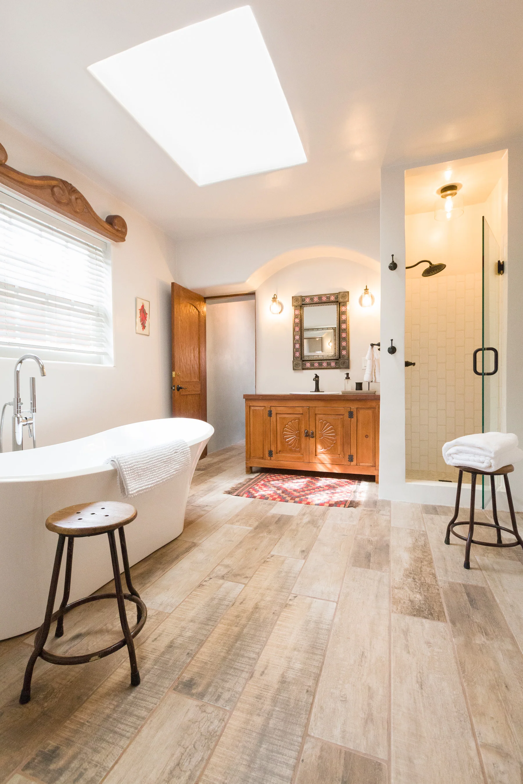 We remodeled the spacious spa ensuite adding a freestanding soaking tub, radiant flooring, marble tiles and a modern rainfall shower.