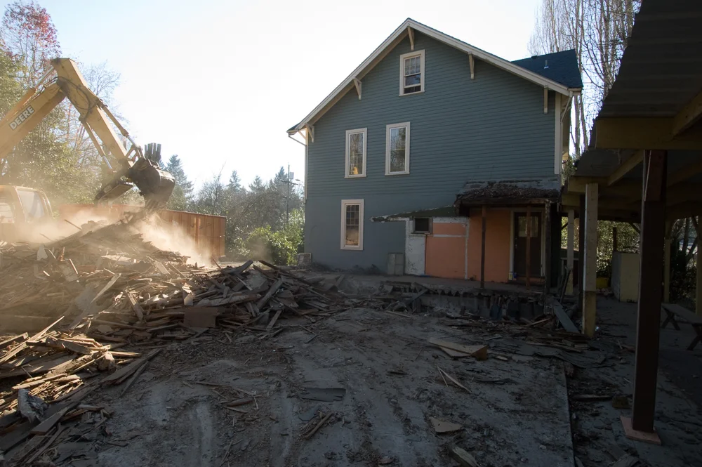 Cascade Peaks t earing down old outbuildings.