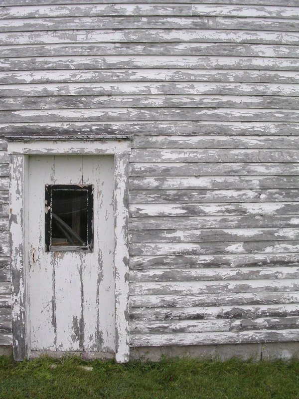 Clap board shed on a roadside in the Bay of Fundy