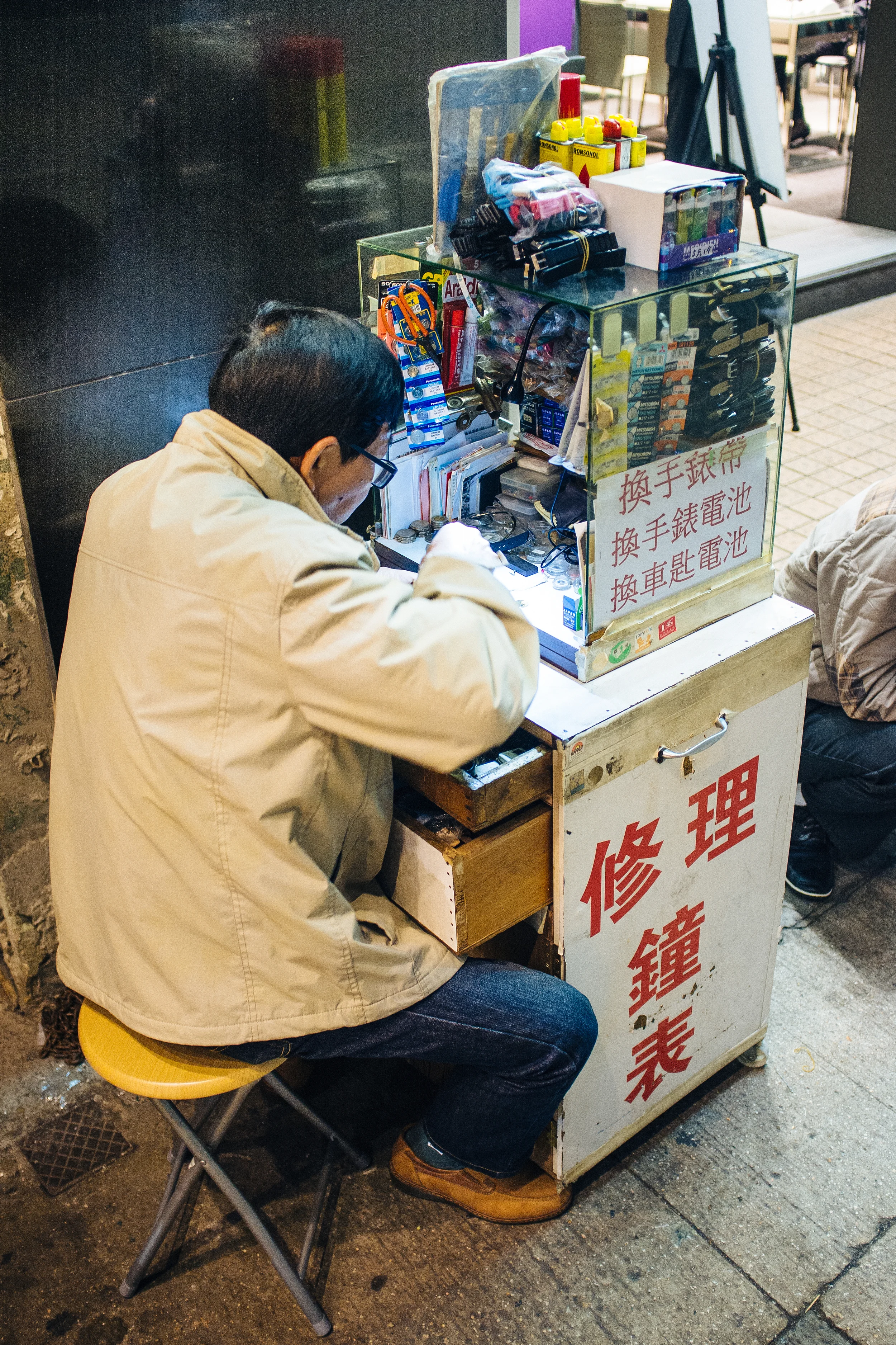 Mong Kok is lousy with these tiny watch repairmen.