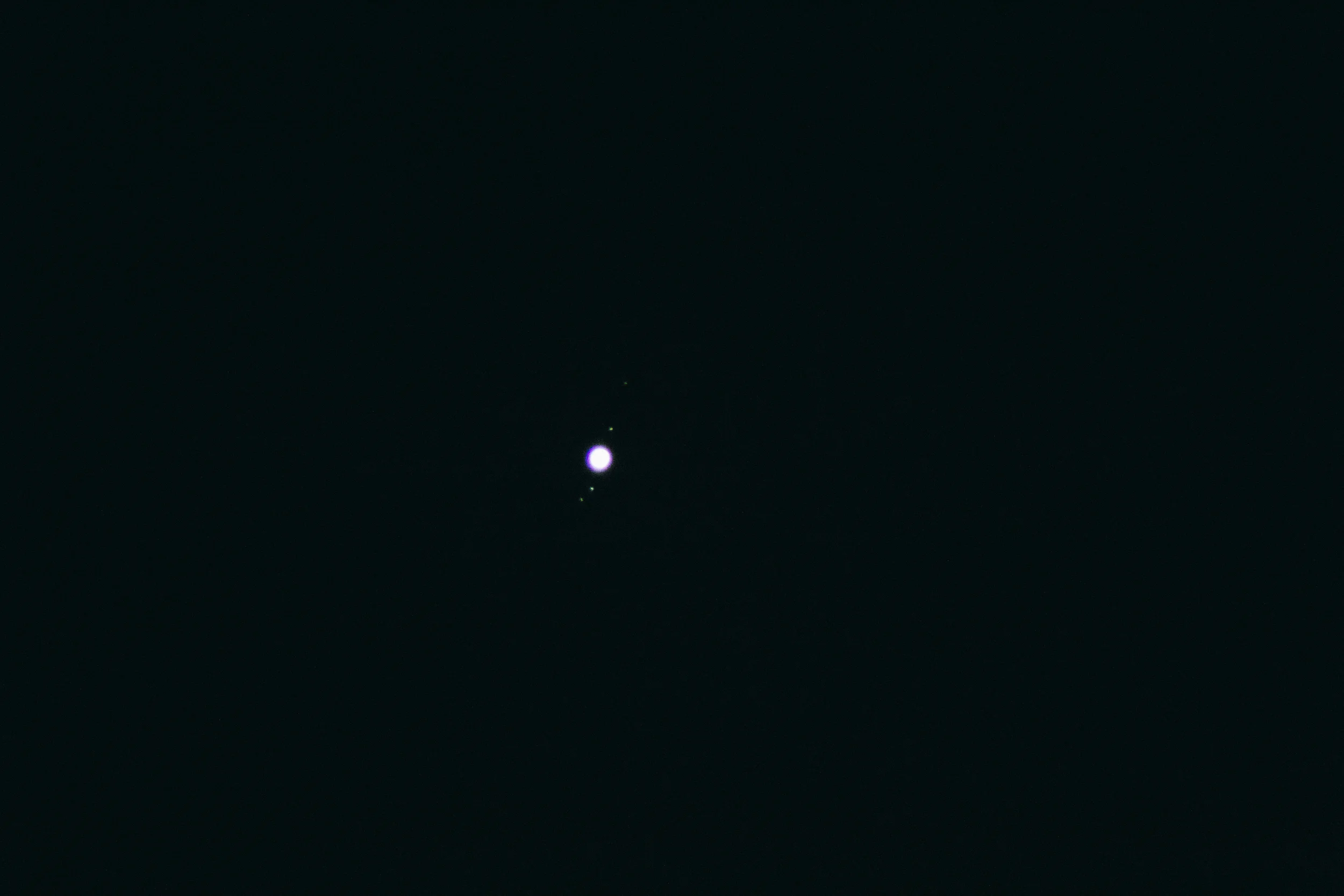 Jupiter, exposed to show several large moons in orbit.