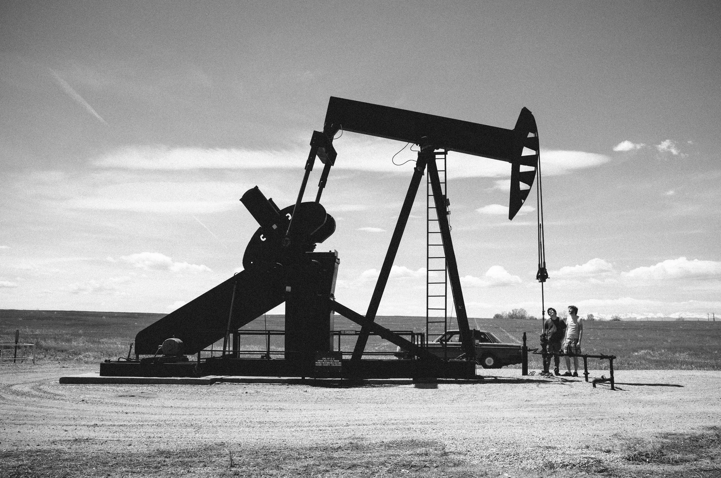 The Plinkertons inspect one of their oil derricks. (Photo by Lucas Hayas / lucashayas.com)