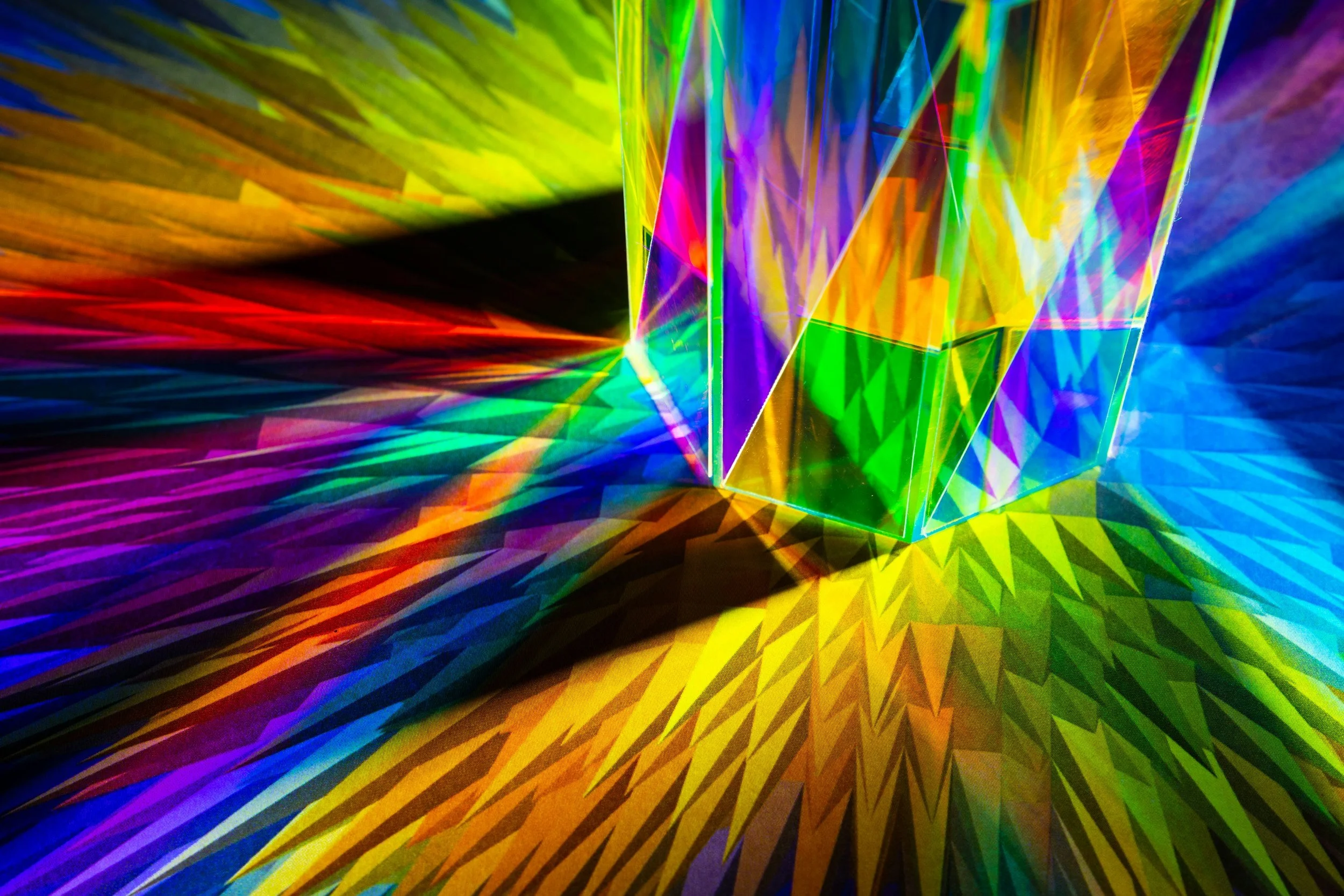 Vibrant rainbow light refracted through crystal prisms — representing LGBTQ+ identity, pride, and the ongoing courage of coming out at any age