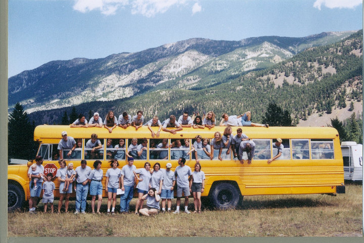 Staff piled on and around a yellow school bus