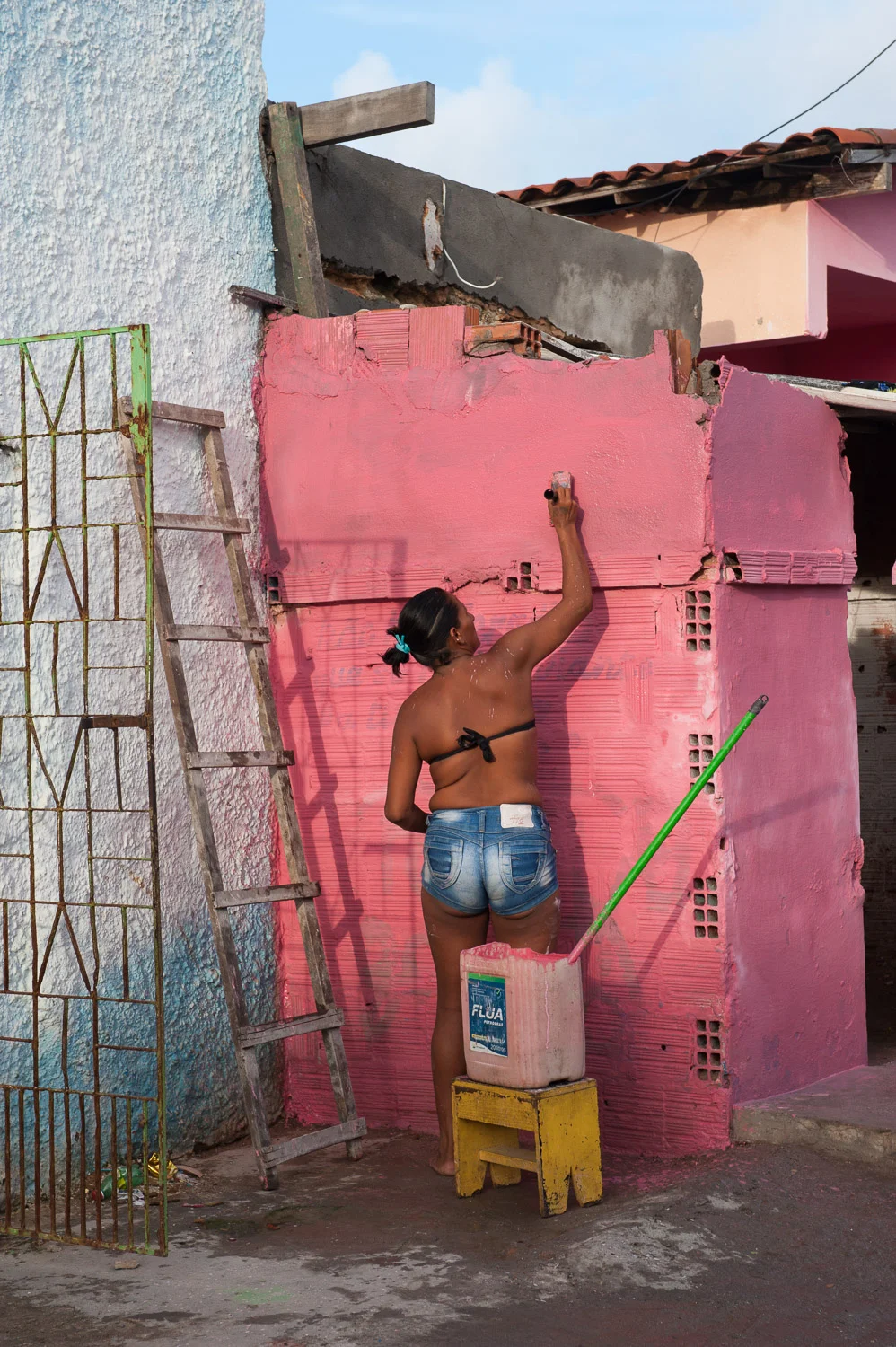In defiance, some favela residents paint over the "X" tag that the City of Fortaleza uses to indicate that a home will be demolished.