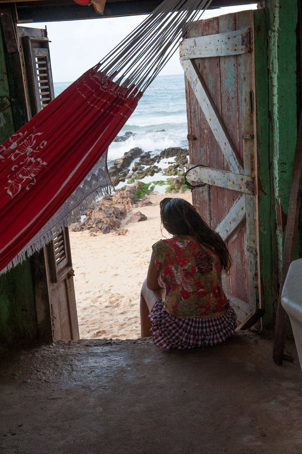 A favela (slum) resident of Fortaleza looks out at the Atlantic Ocean.