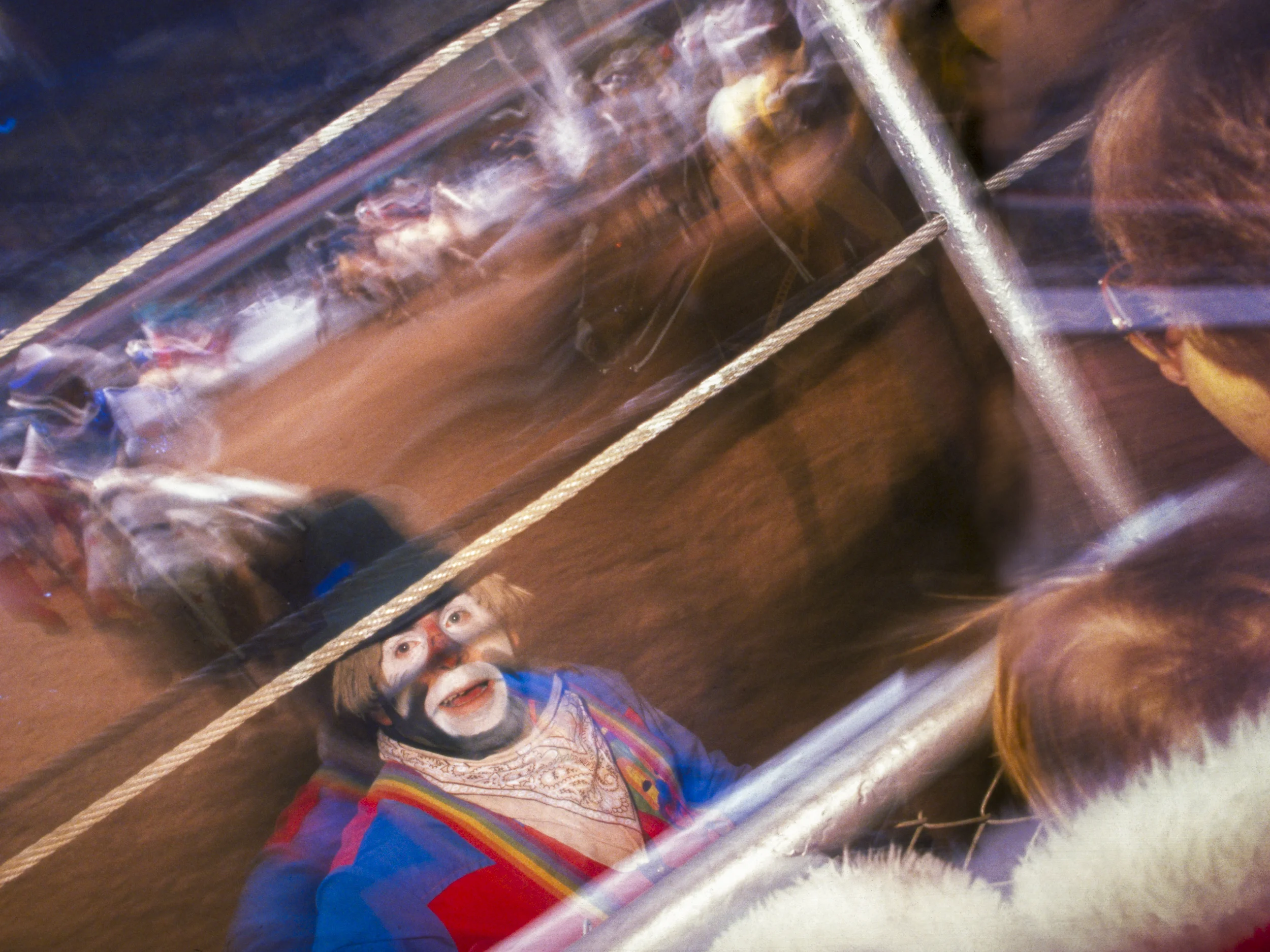 Strobe light and long shutter special effect add dynamic element to image of rodeo clown and his audience. Copyright © Kipp Baker, All rights reserved