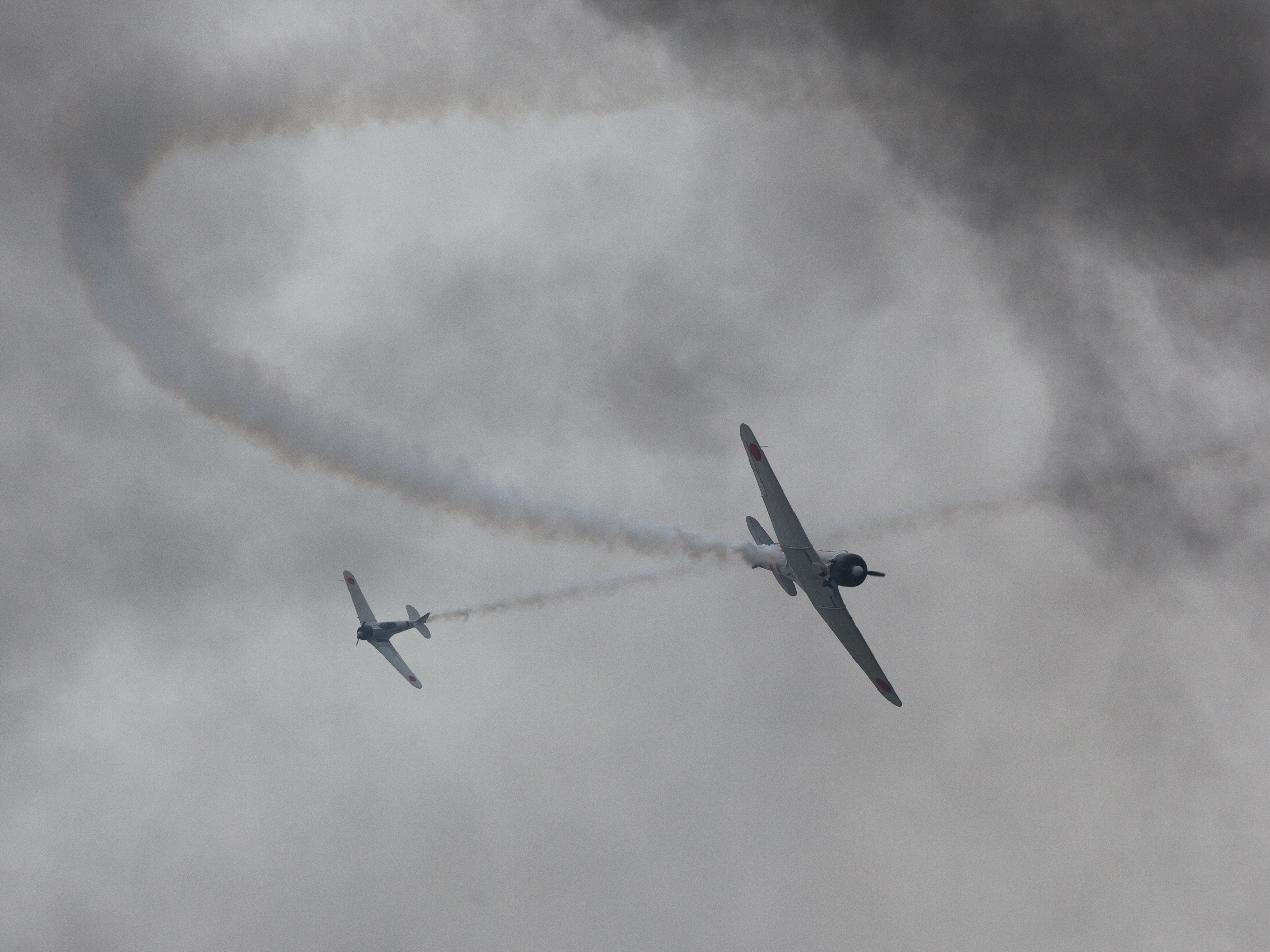Japanese Zero aircraft fighters swoop in smoke patterns during the Pearl Harbor re-enactment, Alliance Air Show, near Fort Worth, TX, USA Copyright © Kipp Baker, All rights reserved.