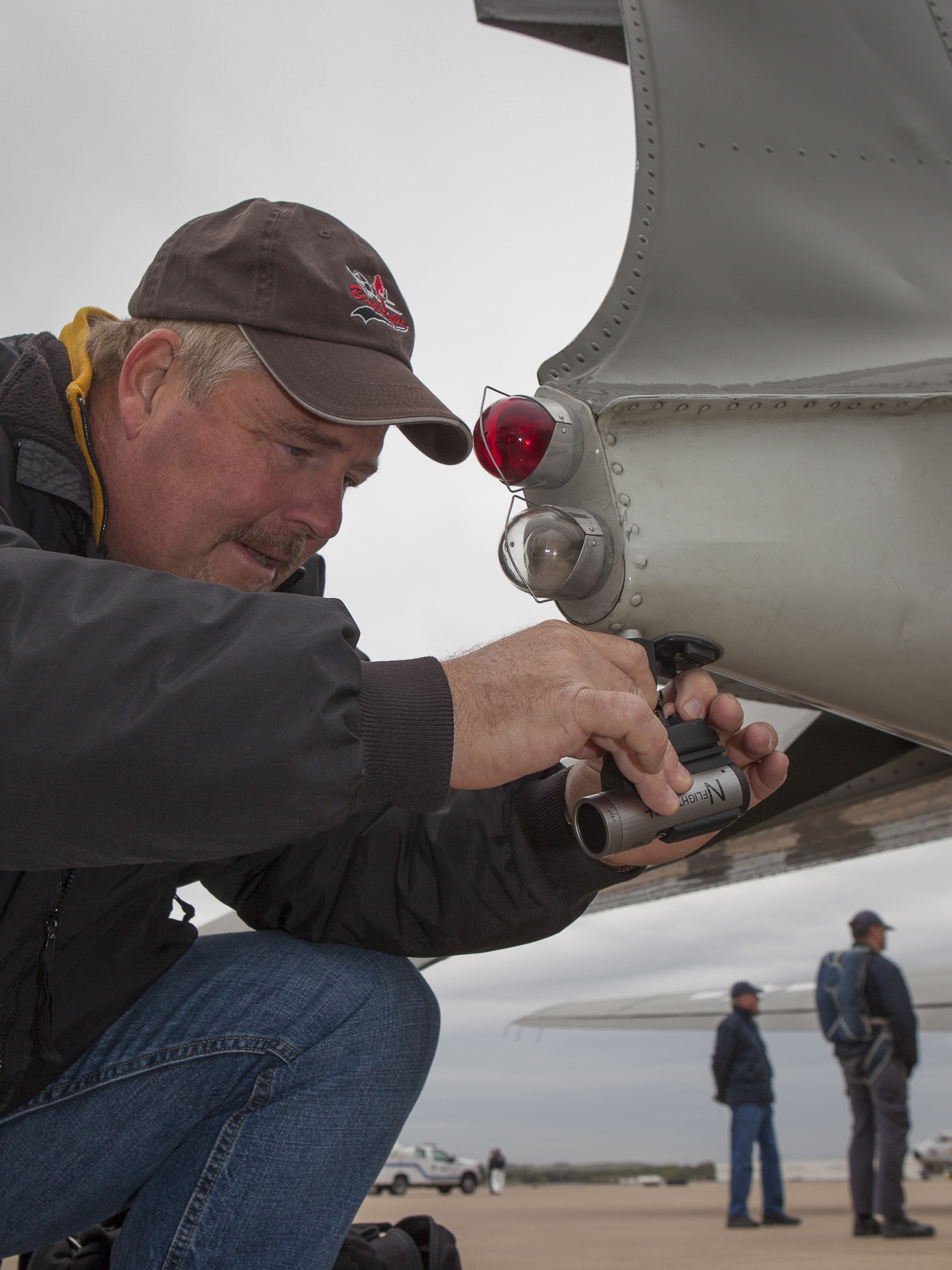 Alliance Air Show field tech attaches video camera for parachute team. Copyright © Kipp Baker, All rights reserved.