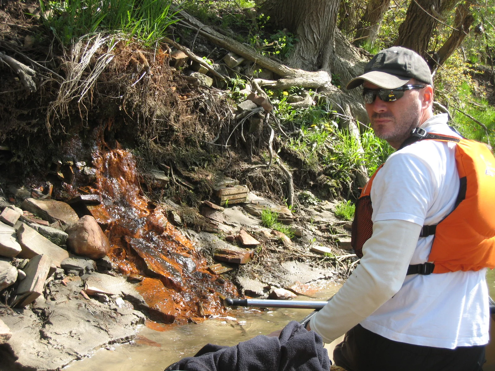 Mark Mattson investigates discharge into the Don River during the annual Paddle the Don event. (Photo credit: Julia Hambleton)
