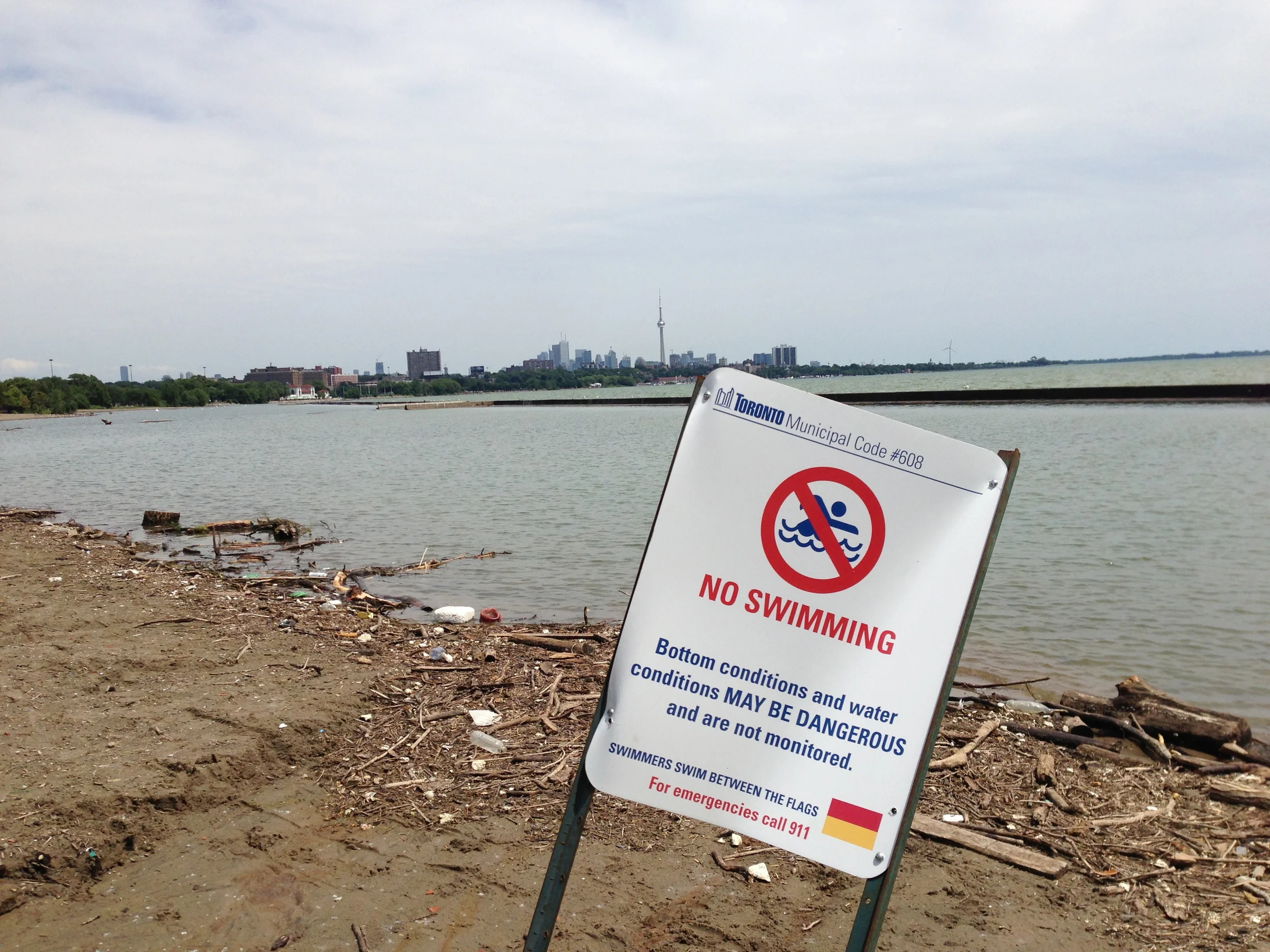 Permanent no swimming sign at the mouth of the Humber River. There are no advisories for people using this area for other recreational activities like paddling. Photo courtesy of Lake Ontario Waterkeeper. July 12, 2013.