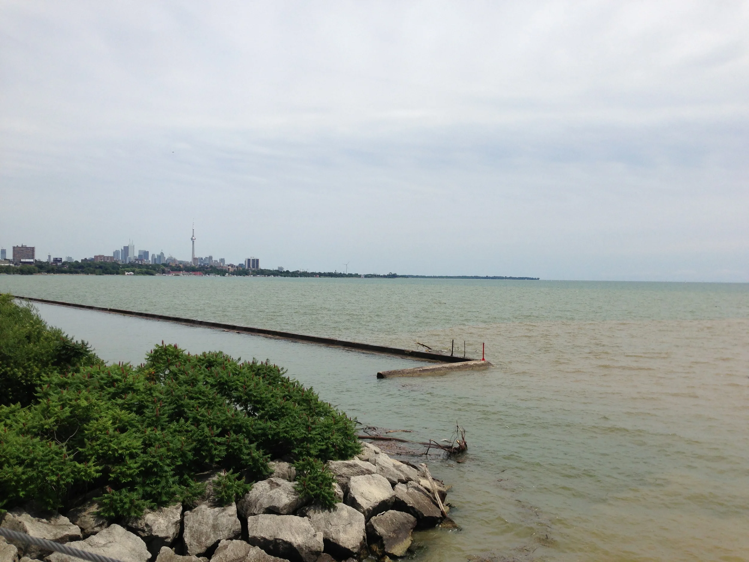 The Humber River turns Lake Ontario brown as it carries sewage into the lake near Sunnyside Beach. Photo taken July 12, 2013 by Krystyn Tully of Lake Ontario Waterkeeper.