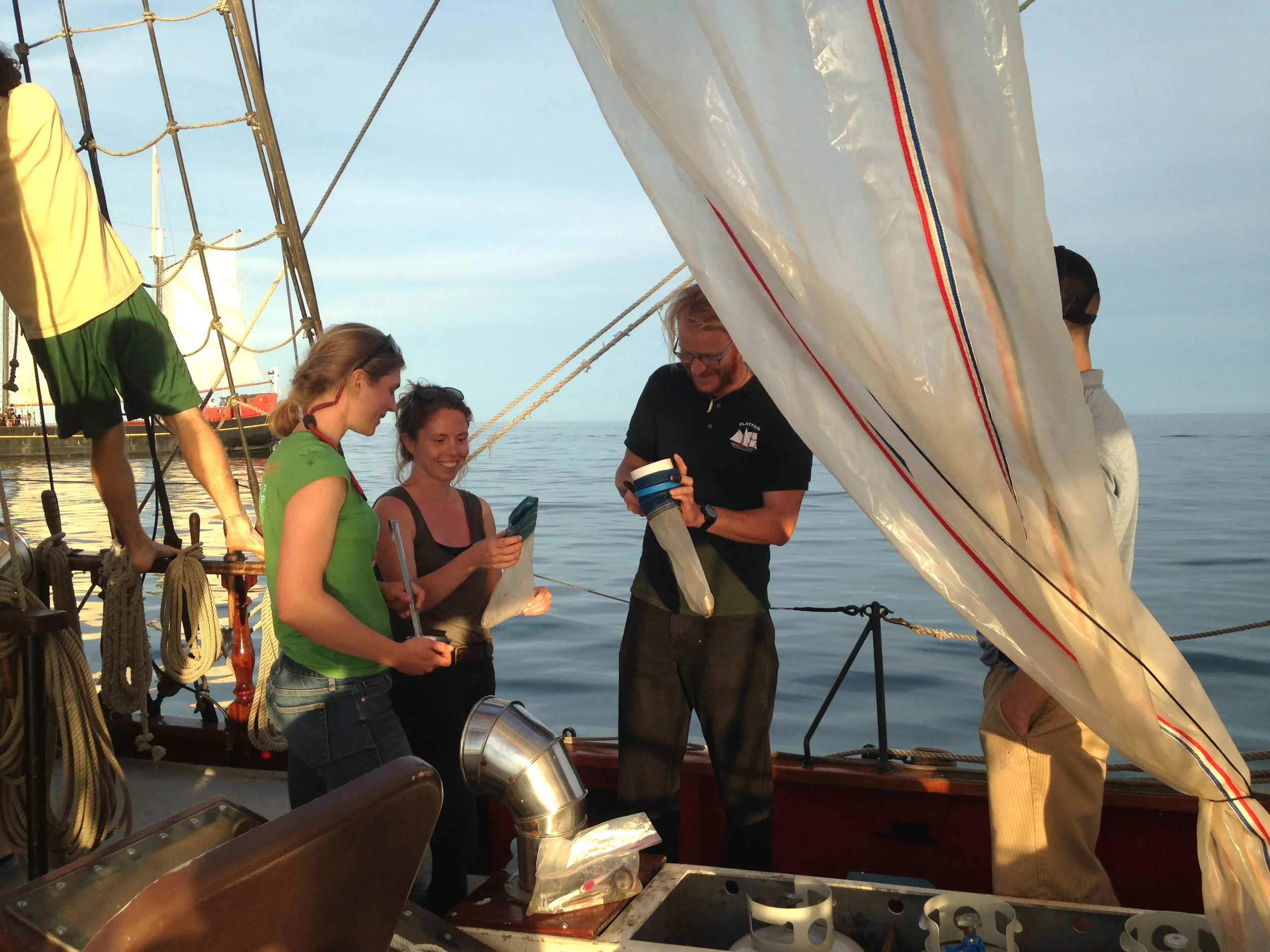 Anika Ballent, Lisa Erdle, and Master Patrick Shore collecting microplastics in Humber Bay. (Photo via Lake Ontario Waterkeeper)
