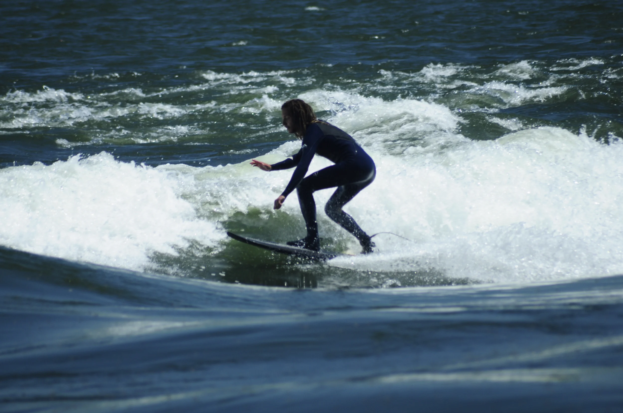 A popular surfing spot in downtown Montreal will be surrounded by sewage release spots if the city goes ahead with its plan to dump 8-billion litres of raw sewage into the river this month. Photo courtesy Pedro fait de la Photo via Flickr. 