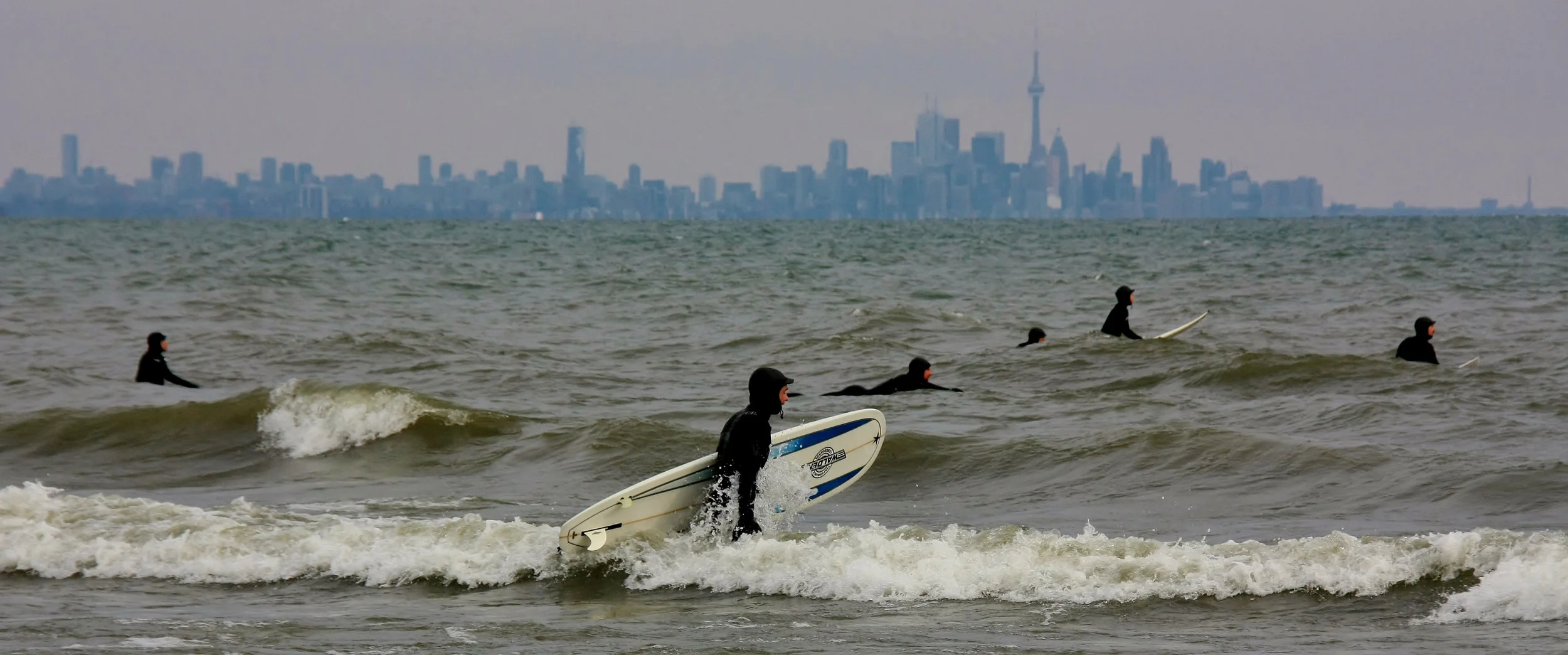 Toronto surfers looking for white caps by the mouth of the Humber River. (Photo via Frances Maas RECE )