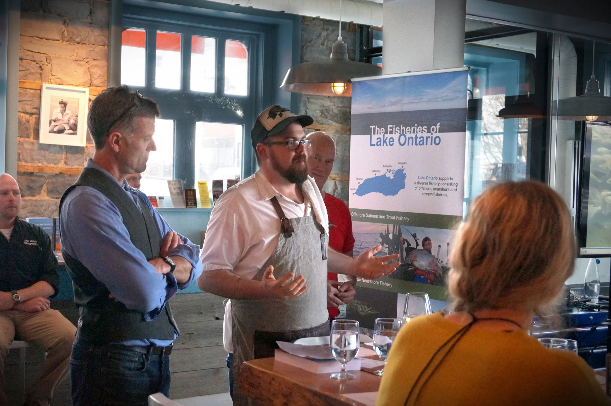 Speakers at the first Eating Lake Ontario event (l-r): The Ministry of Natural Resources' Colin Lake looking on from the back, the Water Access Group' David MacDonald, Dianne's Fish Shack's Chef Paul Dubeau, and Three Dog Winery's John Squair.